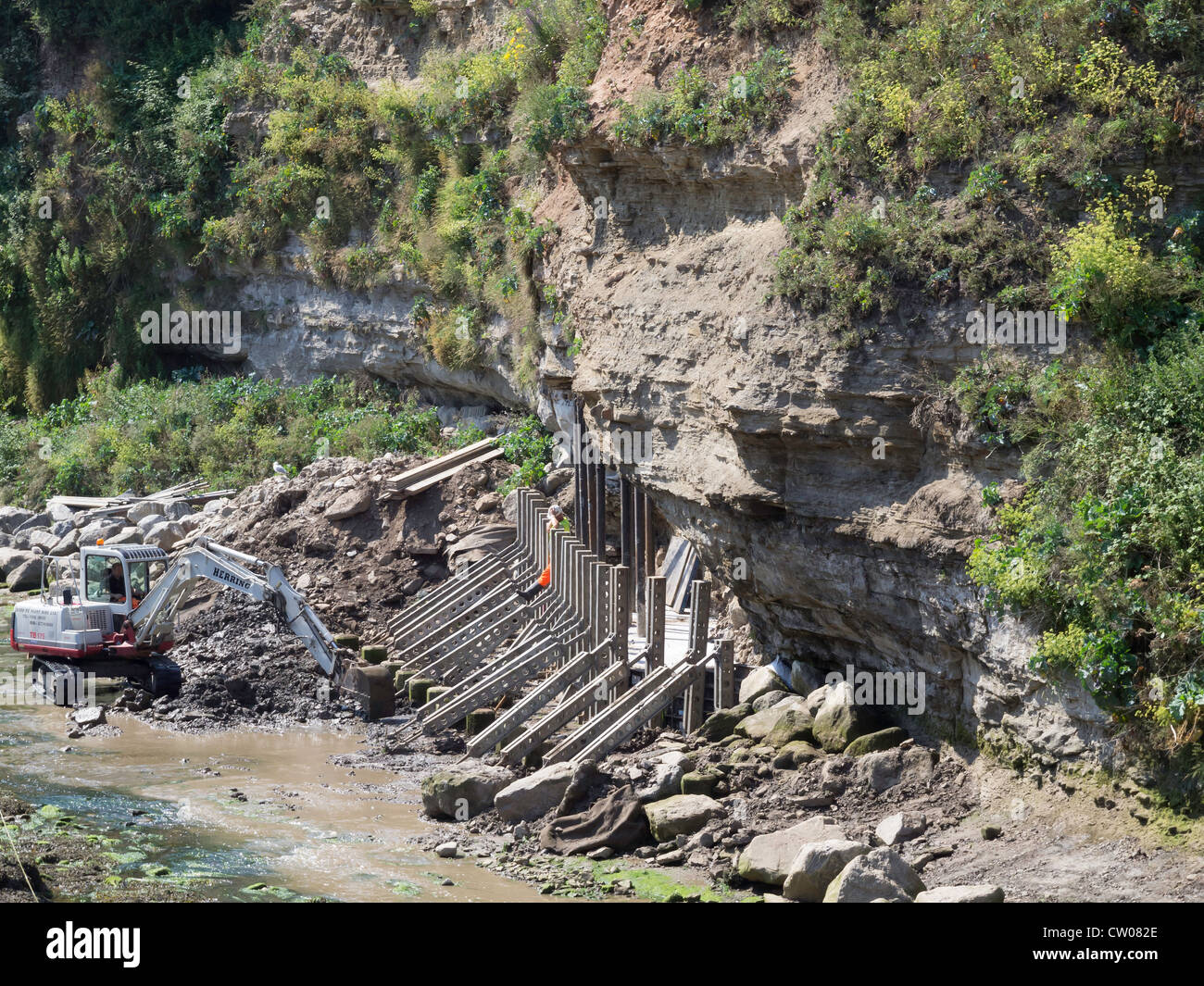 Civil engineering work to underpin a cliff where collapse would put a road and houses at risk Staithes North Yorkshire UK Stock Photo