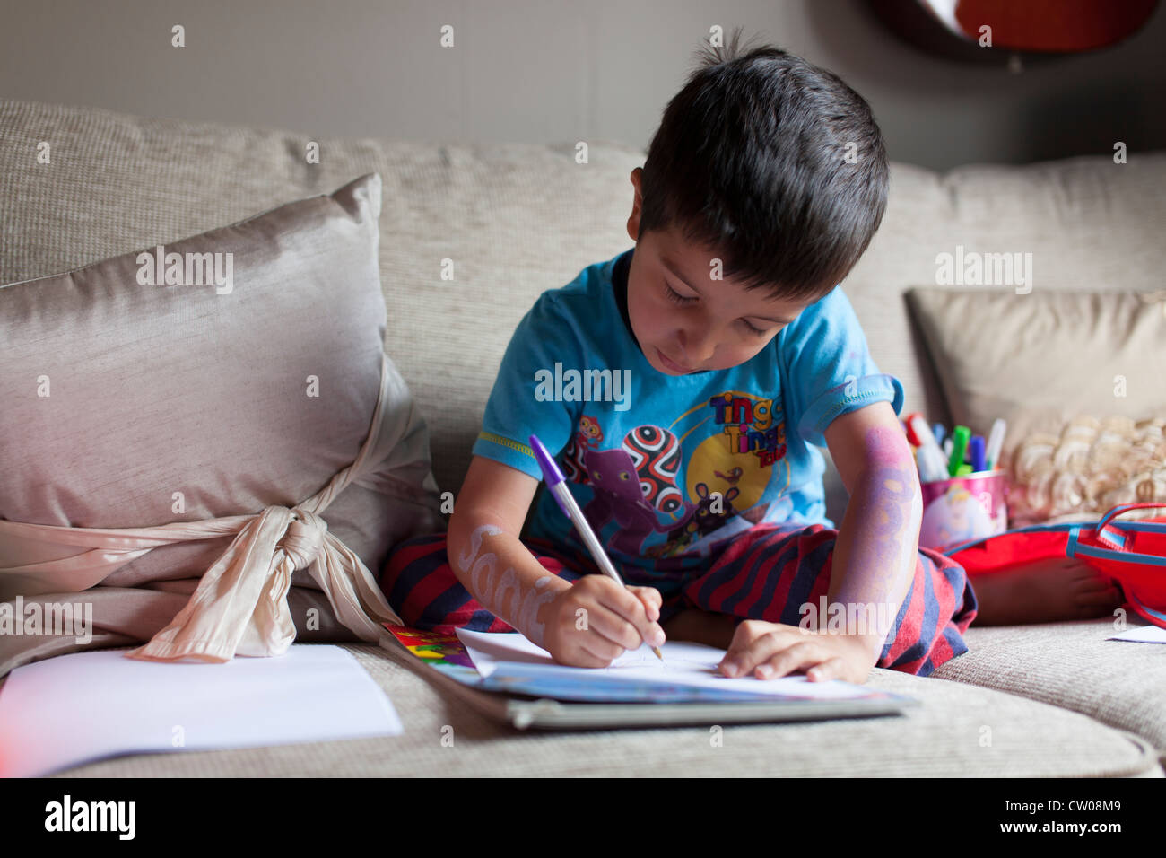 Young boy drawing pictures. Stock Photo