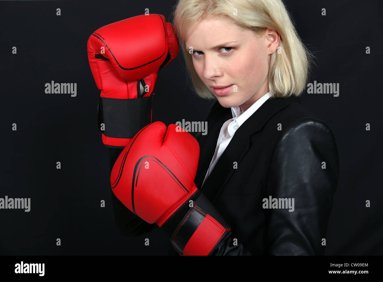 Businesswoman wearing boxing gloves Stock Photo Alamy