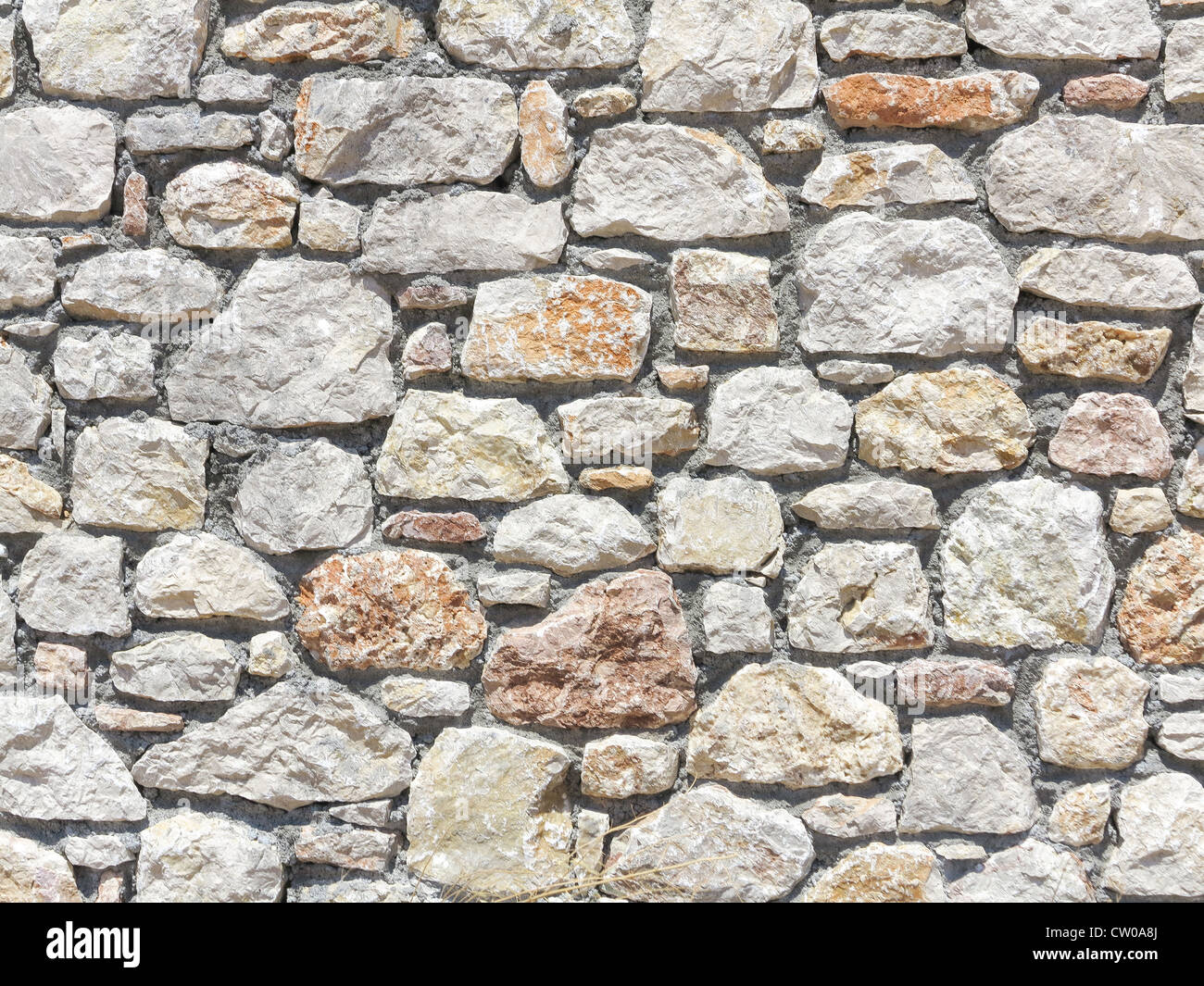 Block stone wall made from irregular sized stone blocks Stock Photo