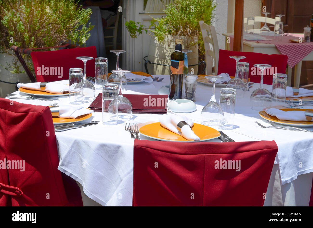 An up market restaurant with tables in the sun and the shade. Image taken in Rhodes, Greece Stock Photo