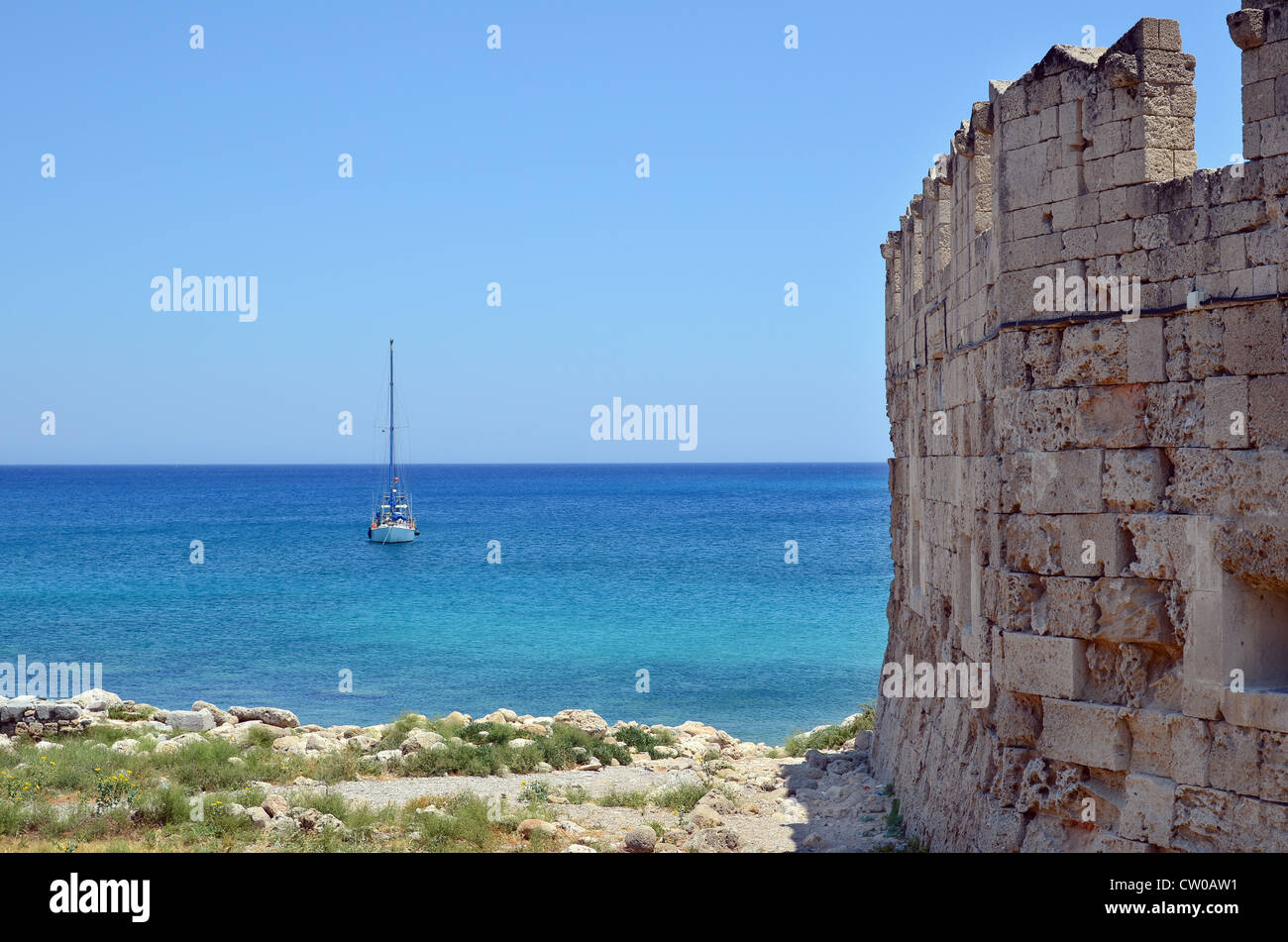 A view out to the Mediterranean sea from beside a fortified wall of the harbour at Rhodes, Greece Stock Photo