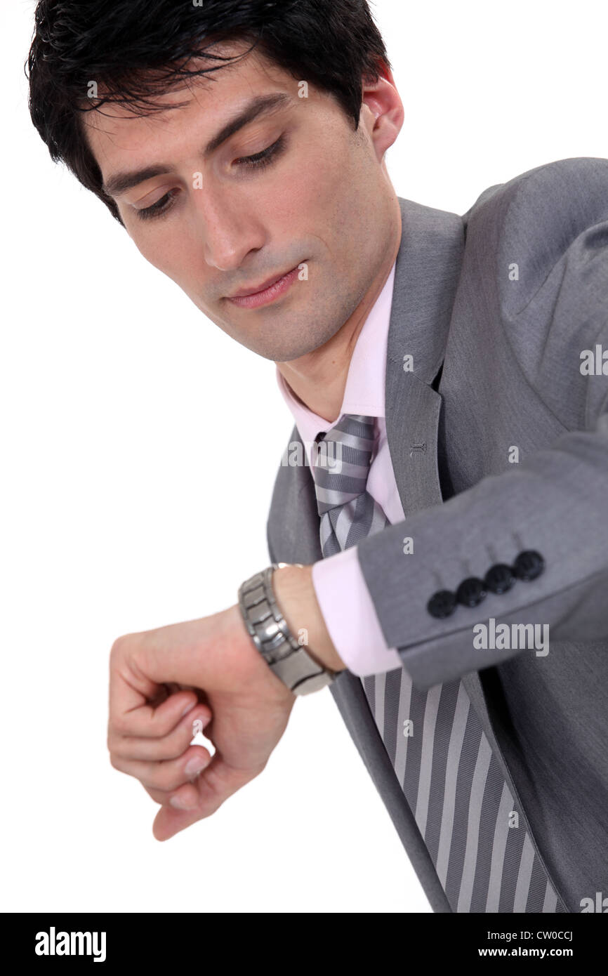 Businessman checking the time Stock Photo - Alamy