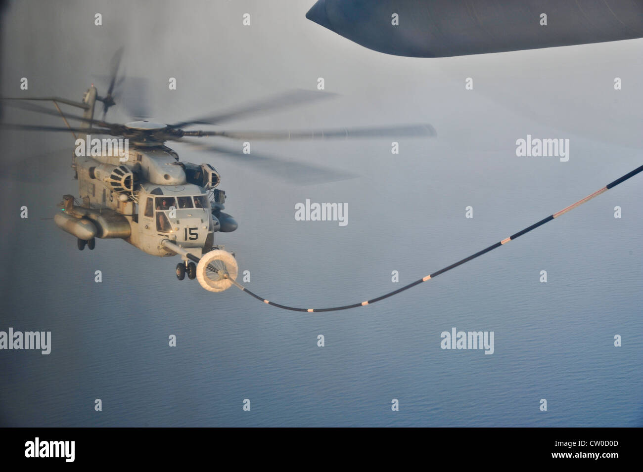 A U.S. Marine Corps CH-53E Super Stallion from Marine Heavy Helicopter Squadron 461 (HMH) conducts aerial refueling from an Air Force HC-130P Combat King with the 81st Expeditionary Rescue Squadron (ERQS) July 30, 2012, over the Gulf of Tadjoura, Djibouti. The 81st ERQS and HMH 461 were conducting training exercises in support of Combined Joint Task Force - Horn of Africa. Stock Photo