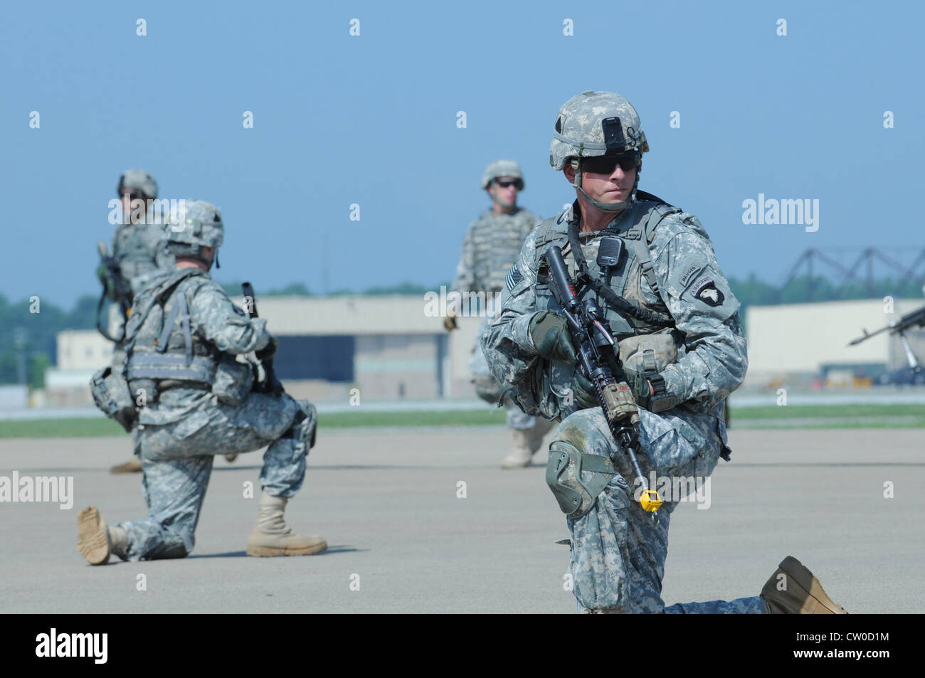A Fort Campbell Soldier pulls security as his teammates get into place before a swarm of helicopters fly over Campbell Army Air Field Tuesday. This demonstration was a rehearsal for the air assault that will occur Saturday as part of the Fort Campbell air show, which begins at 10 a.m. Stock Photo