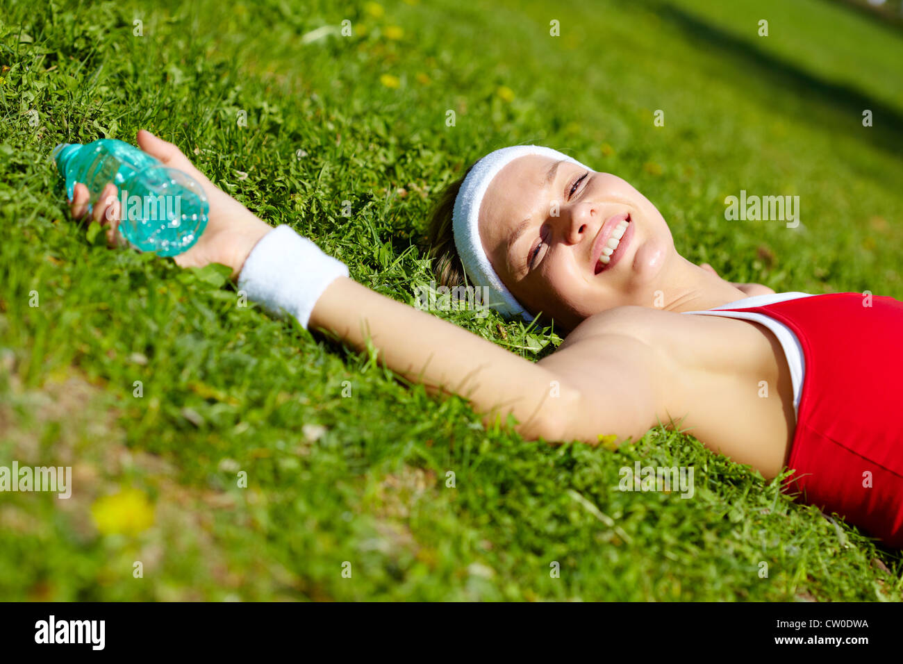 Portrait of a young woman relaxing outdoors Stock Photo - Alamy