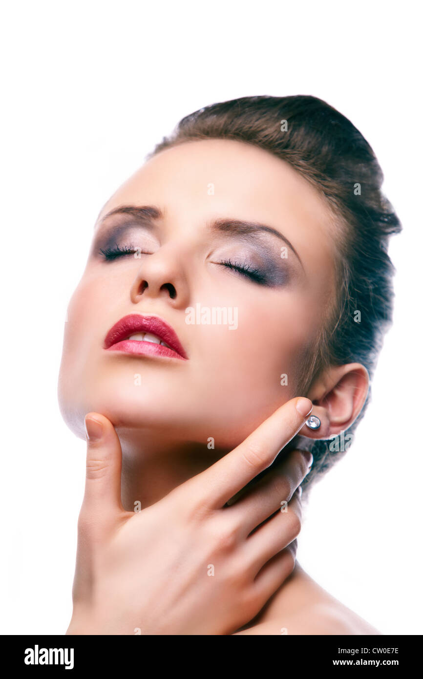 Gorgeous young woman with closed eyes touching her face Stock Photo - Alamy
