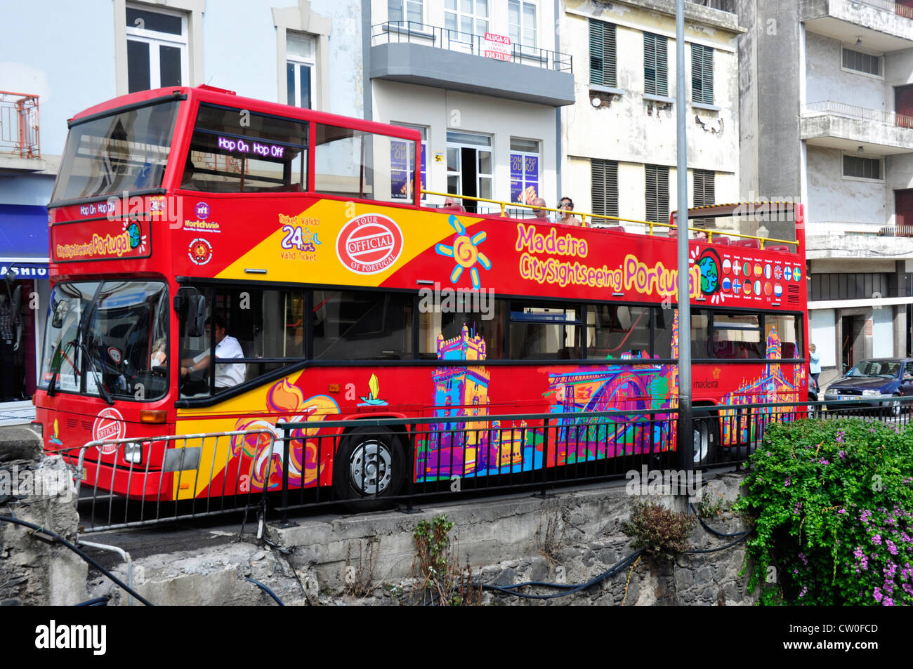 Portugal - Madeira island - Funchal town - distinctive red open top bus offering local tours - similar to buses seen in London Stock Photo
