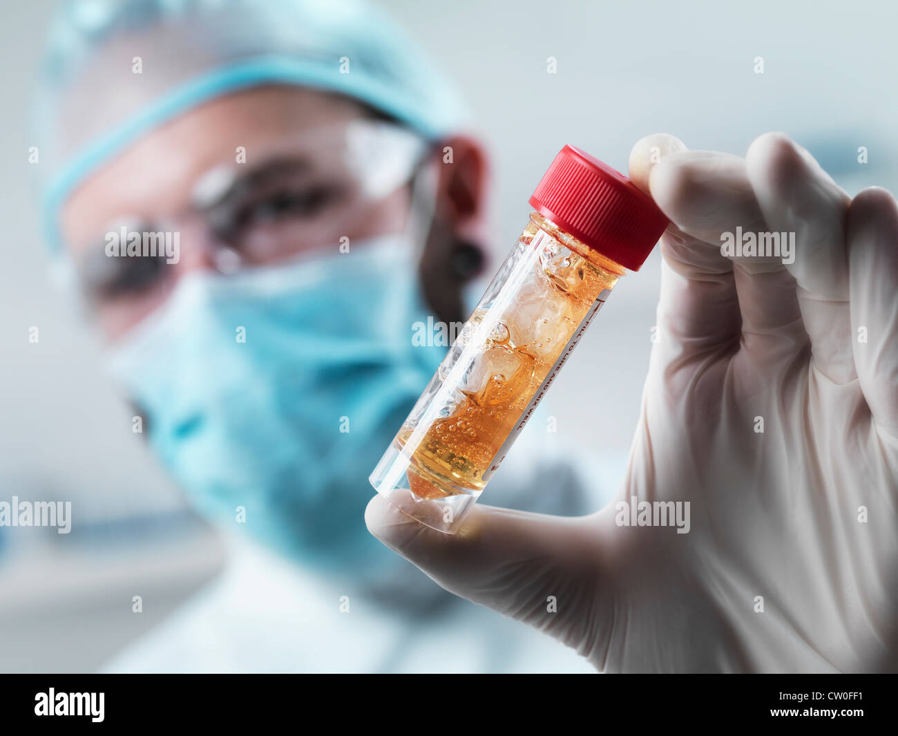 Scientist examining test tube in lab Stock Photo