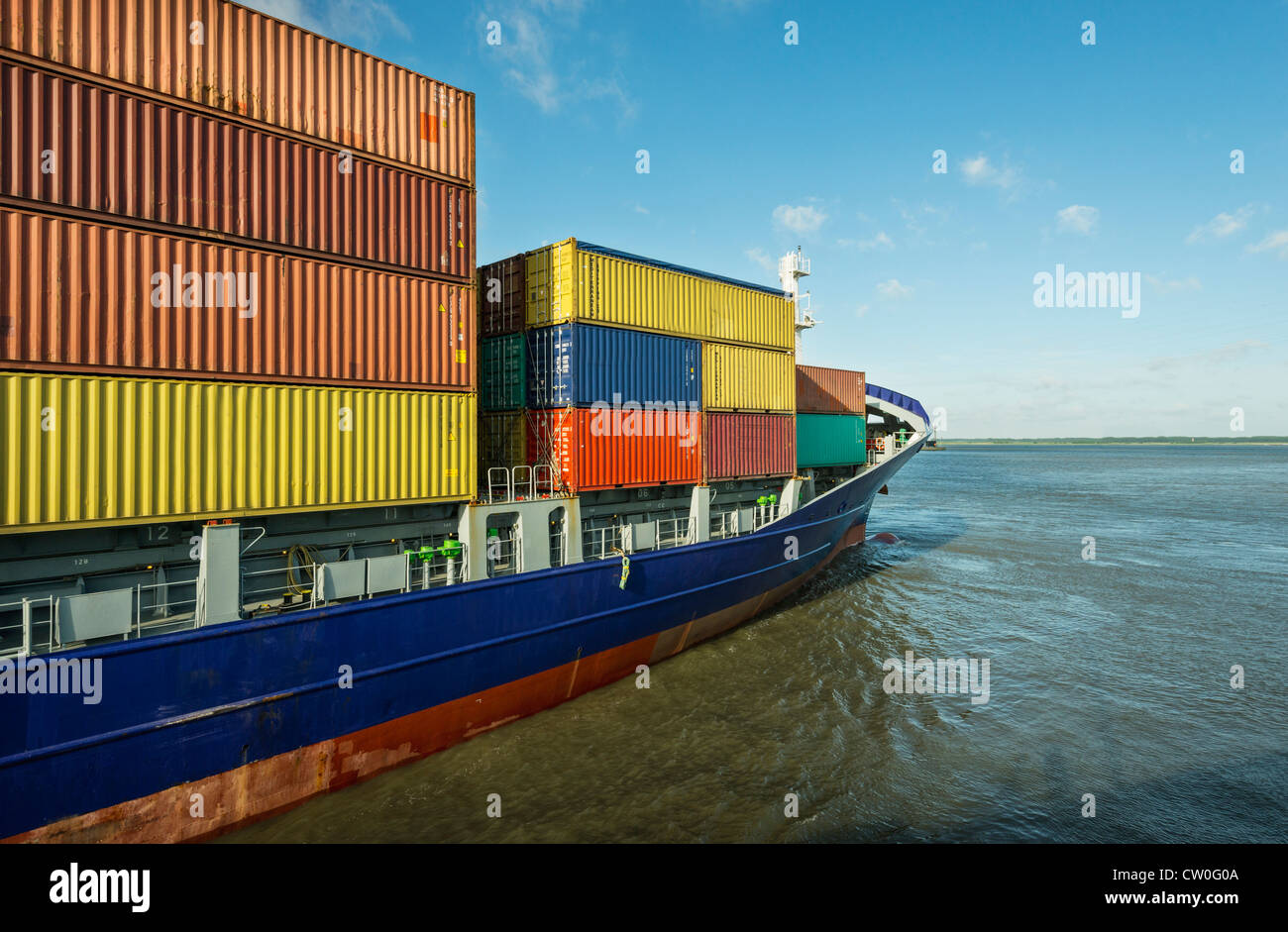 Container ship sailing into harbor Stock Photo