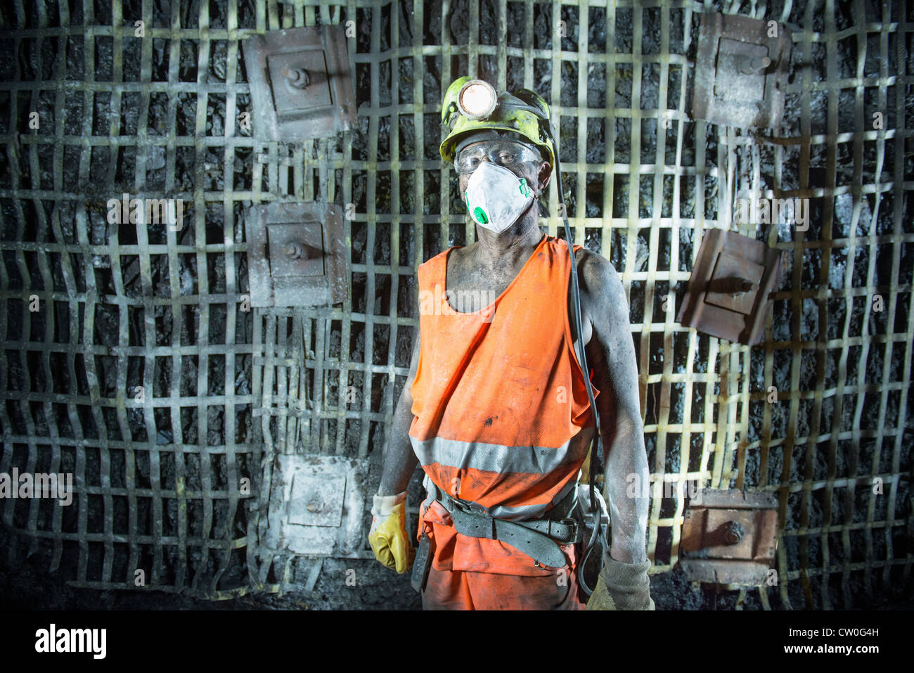 Coal miner standing in mine Stock Photo