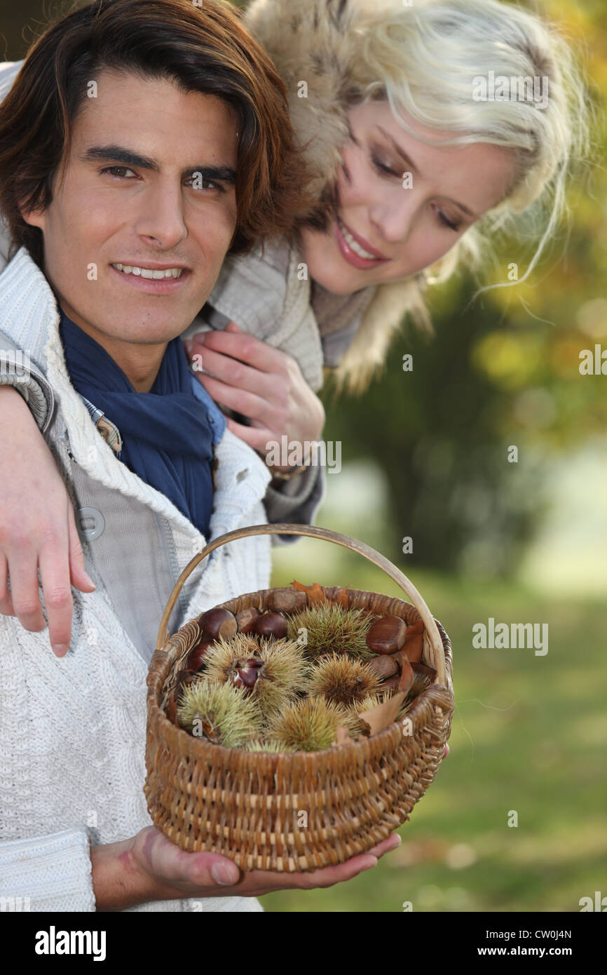 Couple picking chestnuts Stock Photo