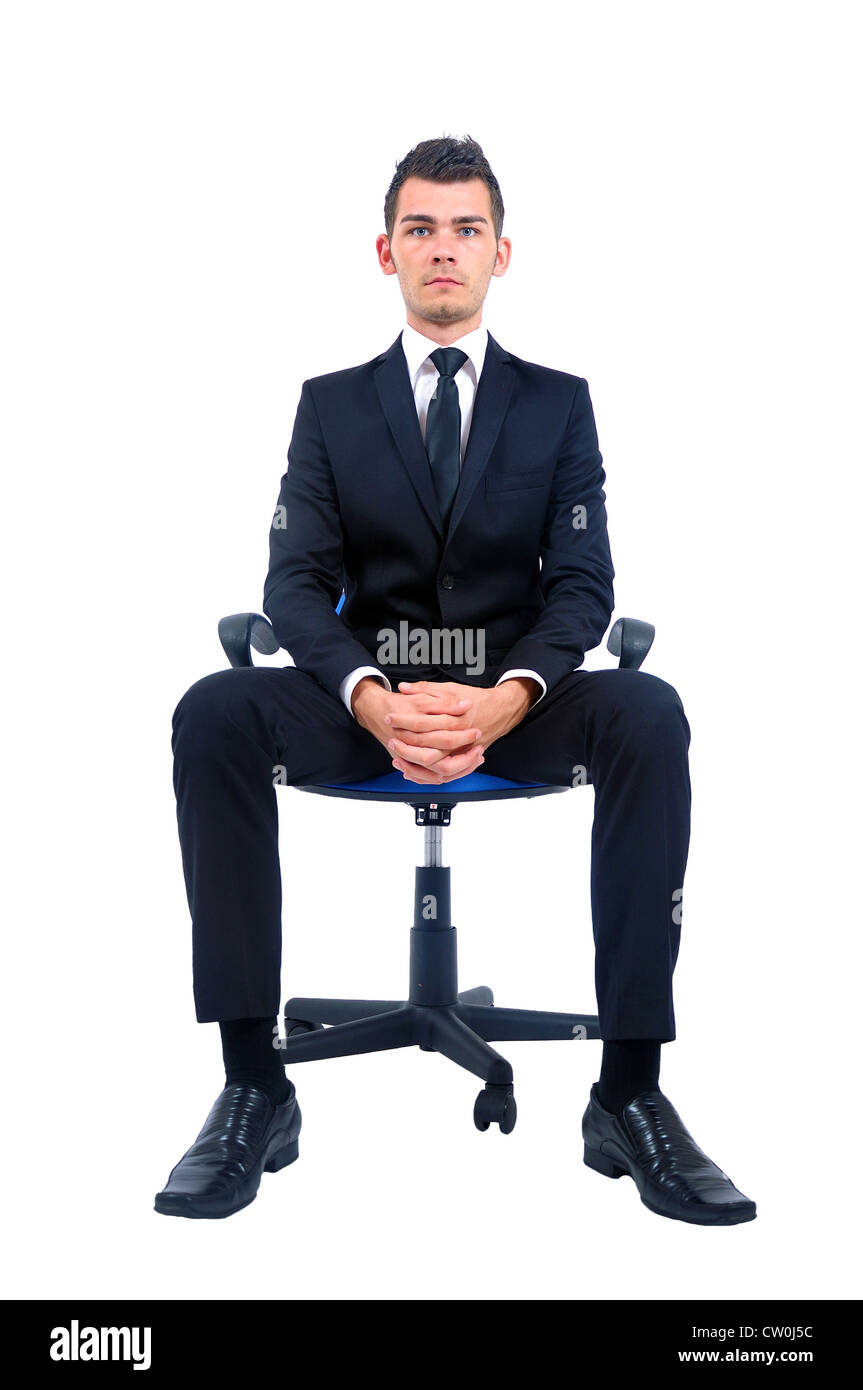 Isolated young business man standing on chair Stock Photo