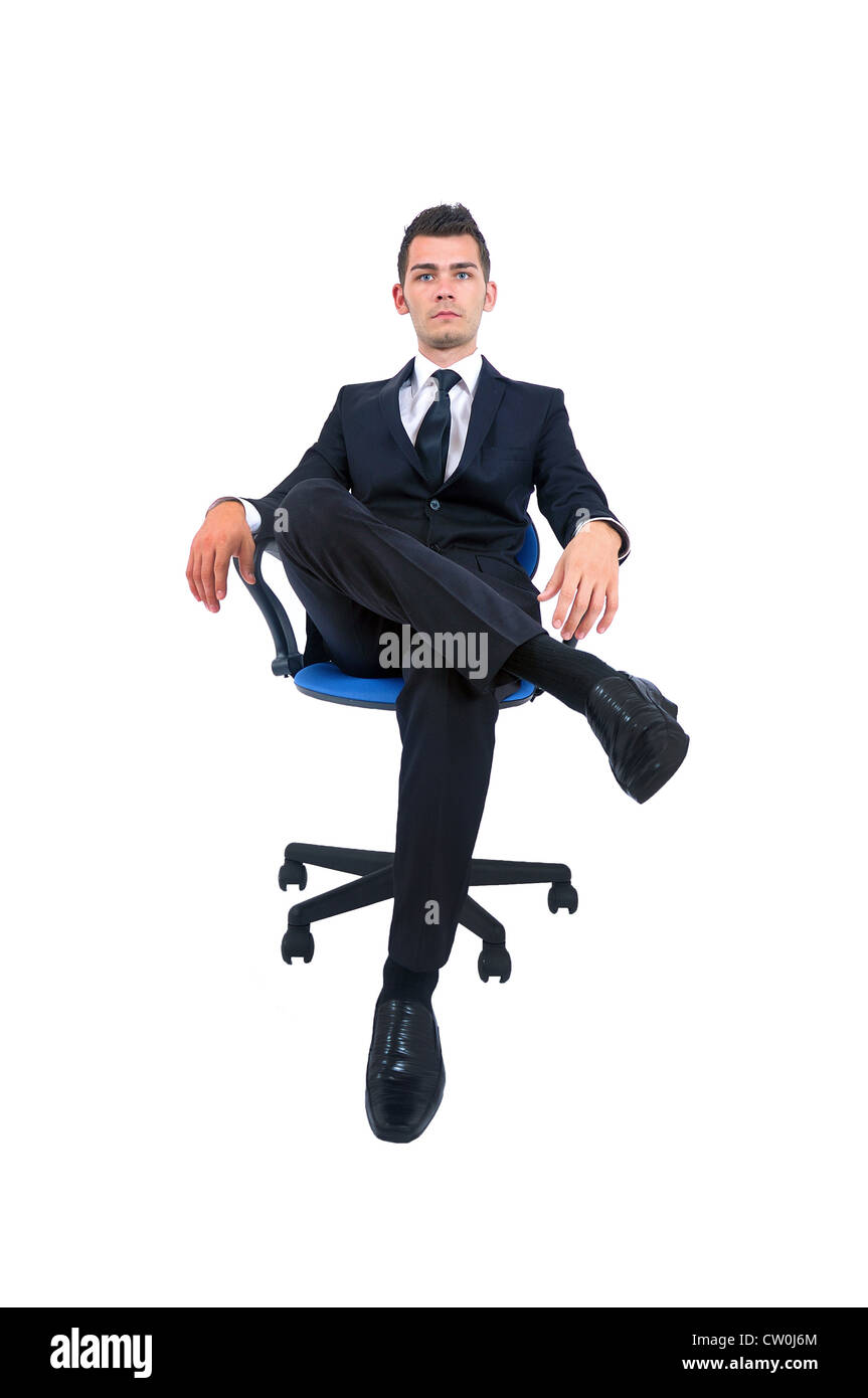 Isolated young business man standing on chair Stock Photo - Alamy