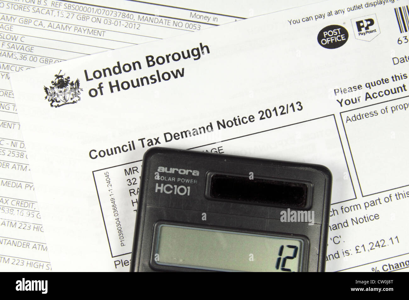 Calculator sitting on a London Borough of Hounslow Council Tax bill 2012.13  and a bank statment Stock Photo - Alamy