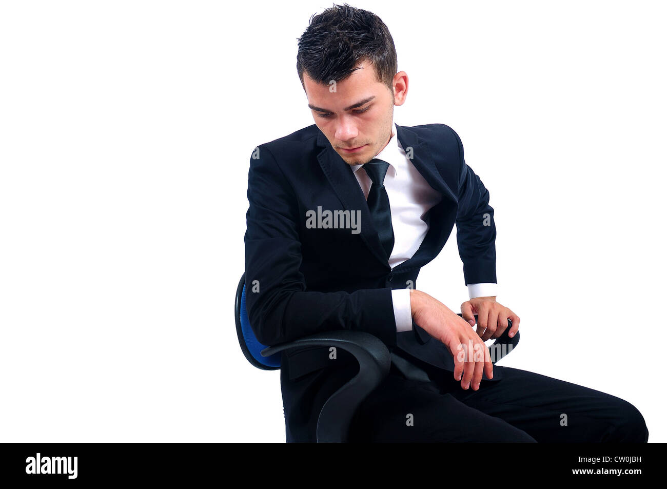 Isolated young business man sitting on chair Stock Photo