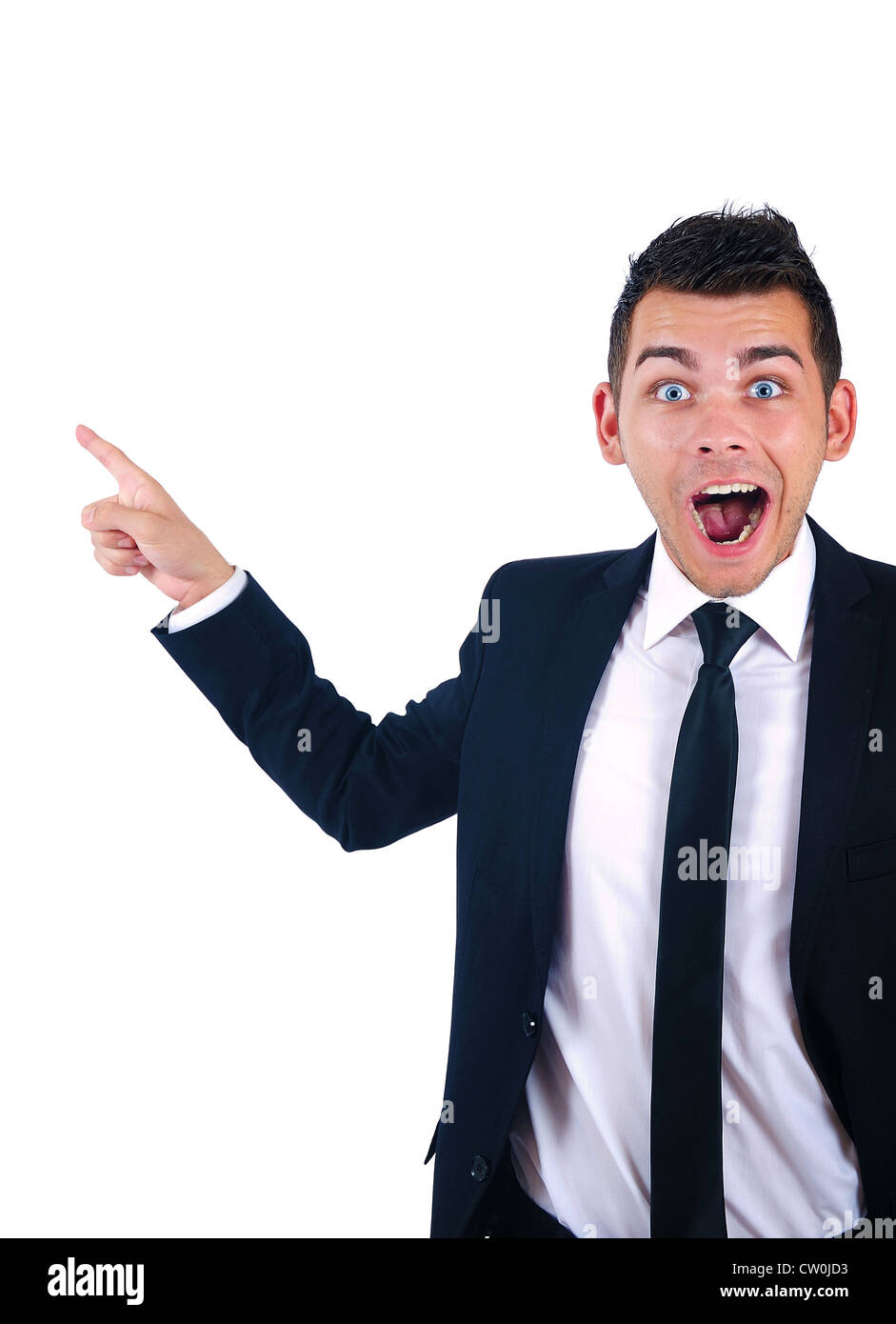 Isolated young business man pointing amazed Stock Photo - Alamy