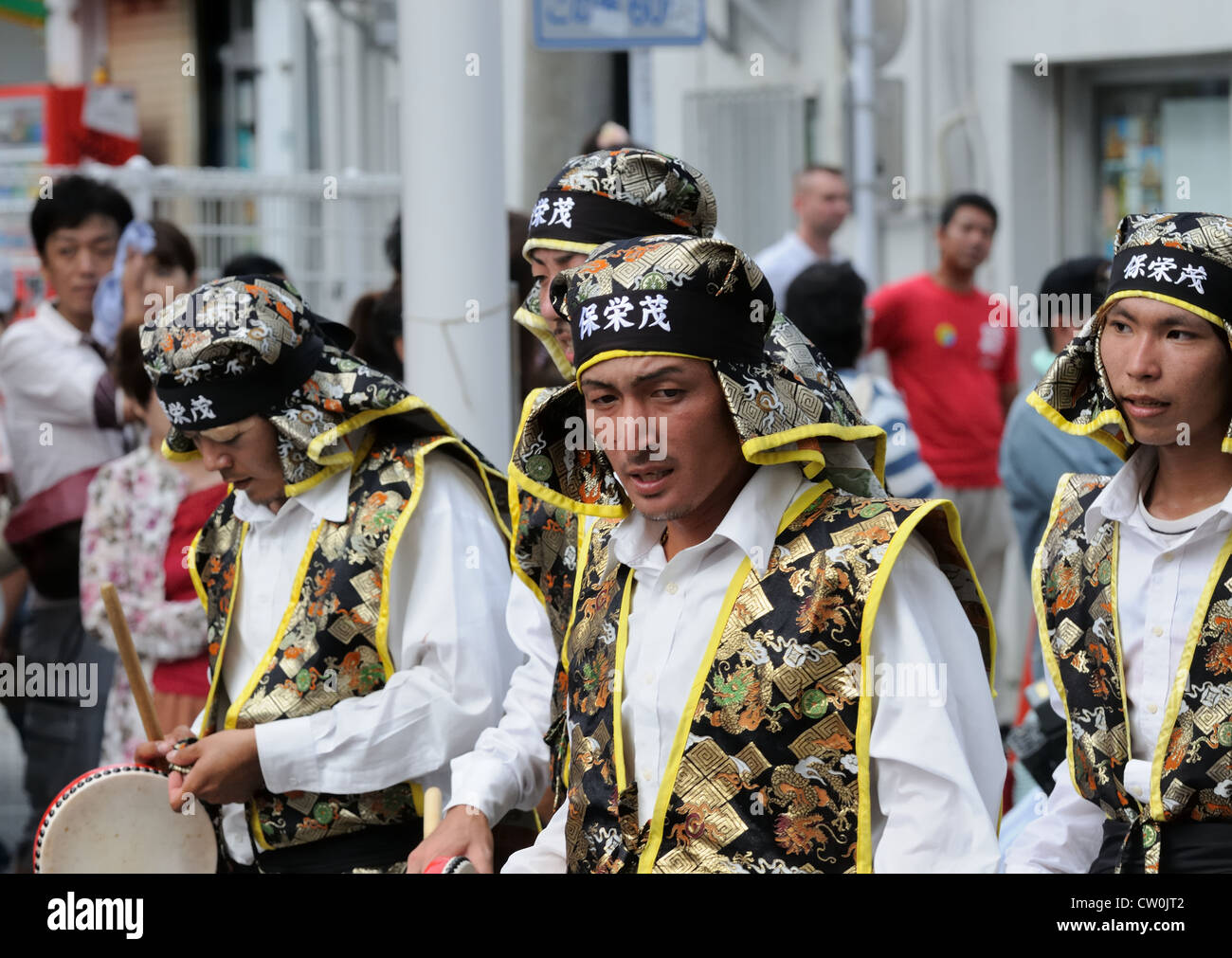 Performers during an 'eisa' festival walk to the next performance location. Stock Photo