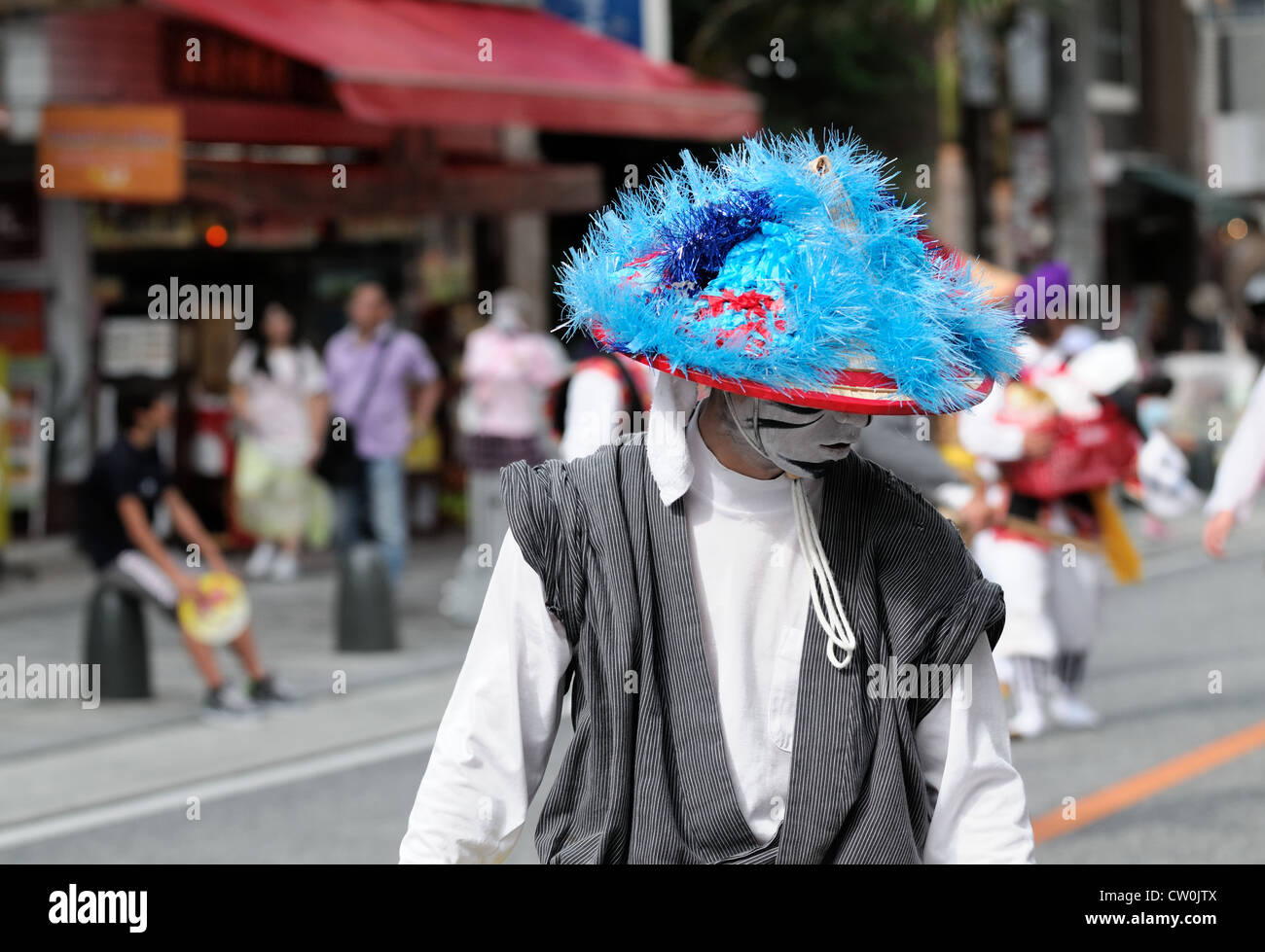A dancer during an 'eisa' event in Naha, Okinawa walks to the next performance location. Stock Photo