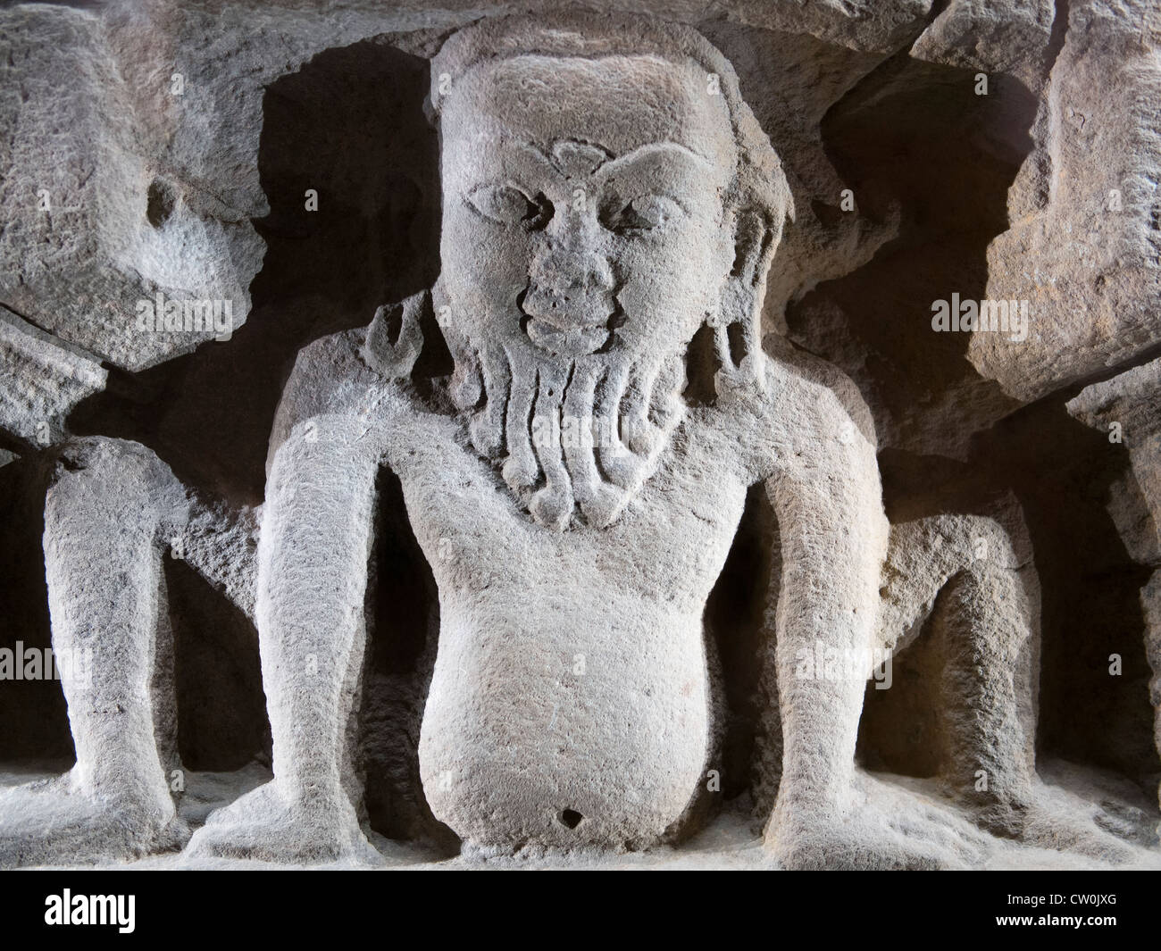 A Nepalese bearded Yaksha - nature spirit - crouches amongst stylised rocks - the Ashmolean Museum, Oxford Stock Photo
