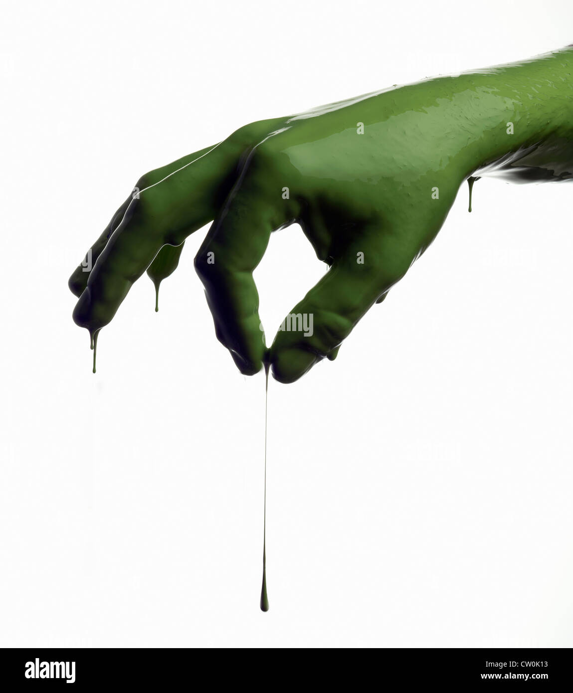 Green painted hand pinching Stock Photo