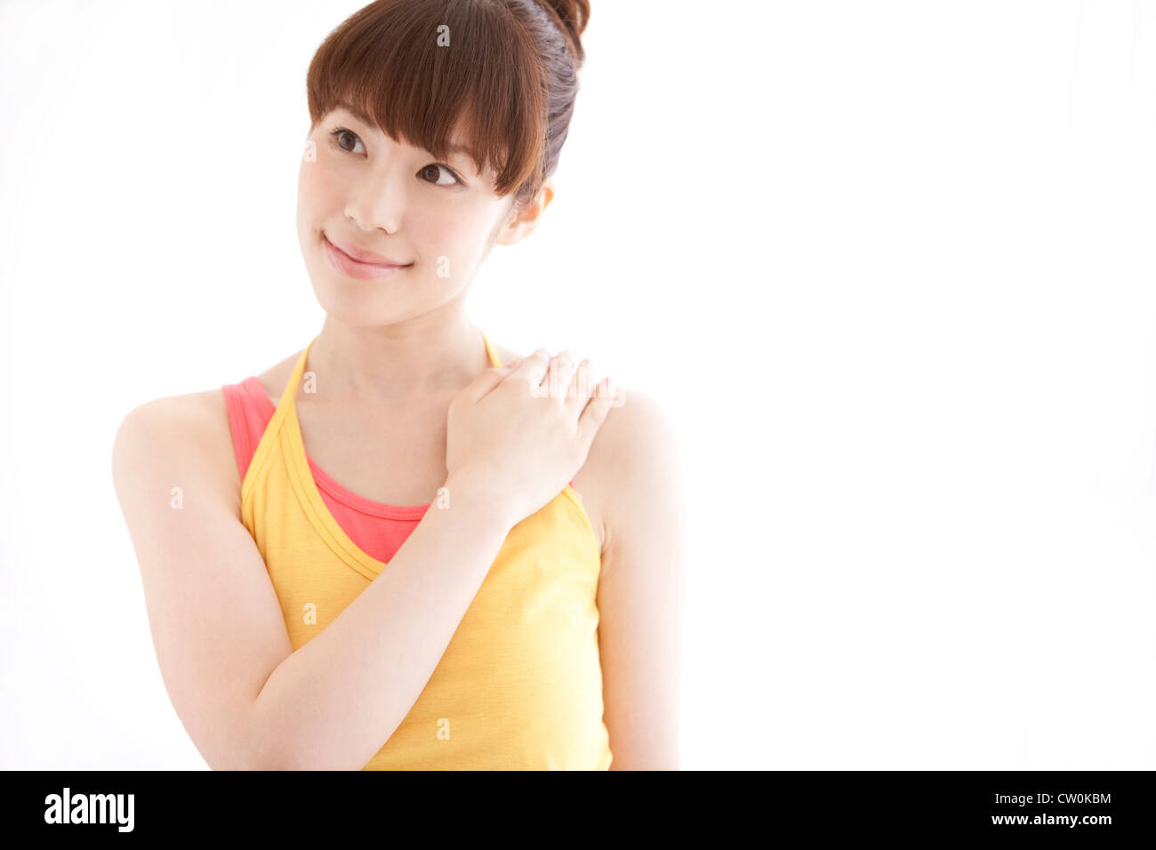 Young woman touching her shoulder Stock Photo - Alamy