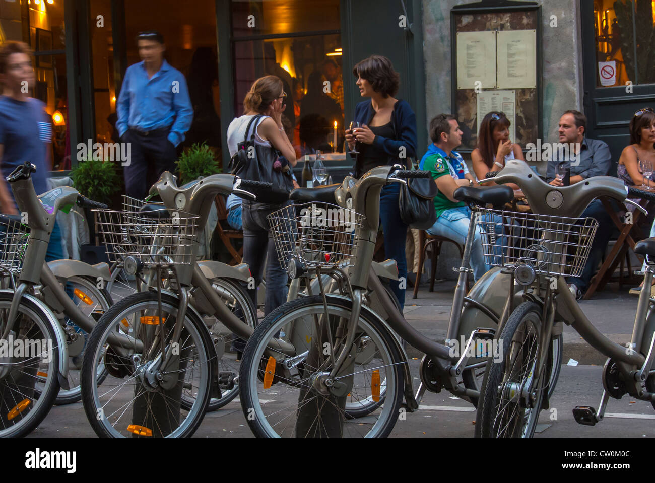 Paris, Cafe, France, Group of Young People, Sharing Drinks on Terrace in Front of French Bar Bistro Restaurant, 'Hotel du Nord' the Canal Saint Martin, Parisian busy street scene JCDecaux, cafe cycling Stock Photo