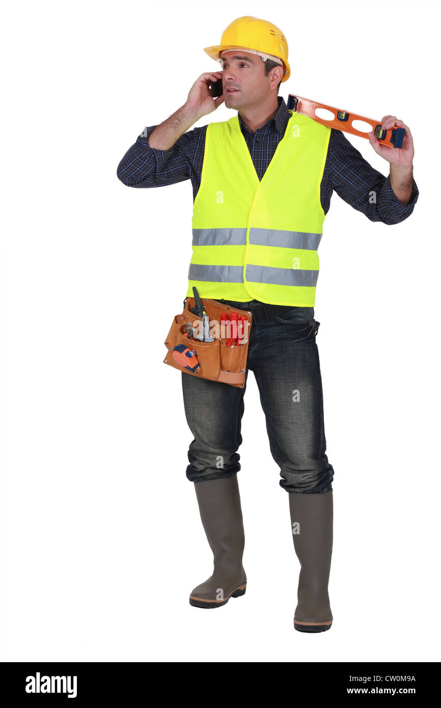Man with spiritlevel making phone call Stock Photo Alamy