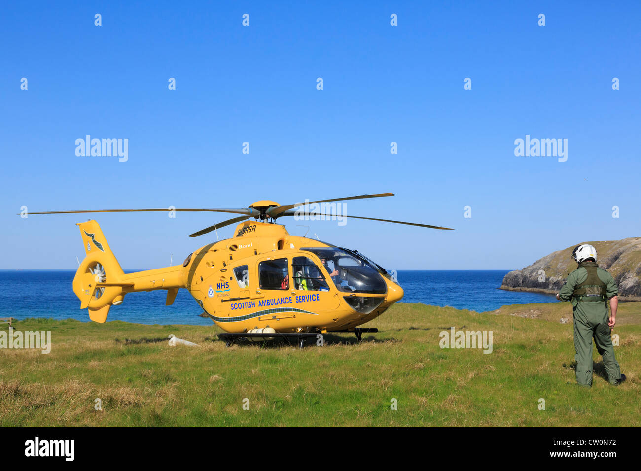 Scottish Air Ambulance Service Helicopter preparing to take off after a rescue mission on remote North West Highlands coast. UK Stock Photo