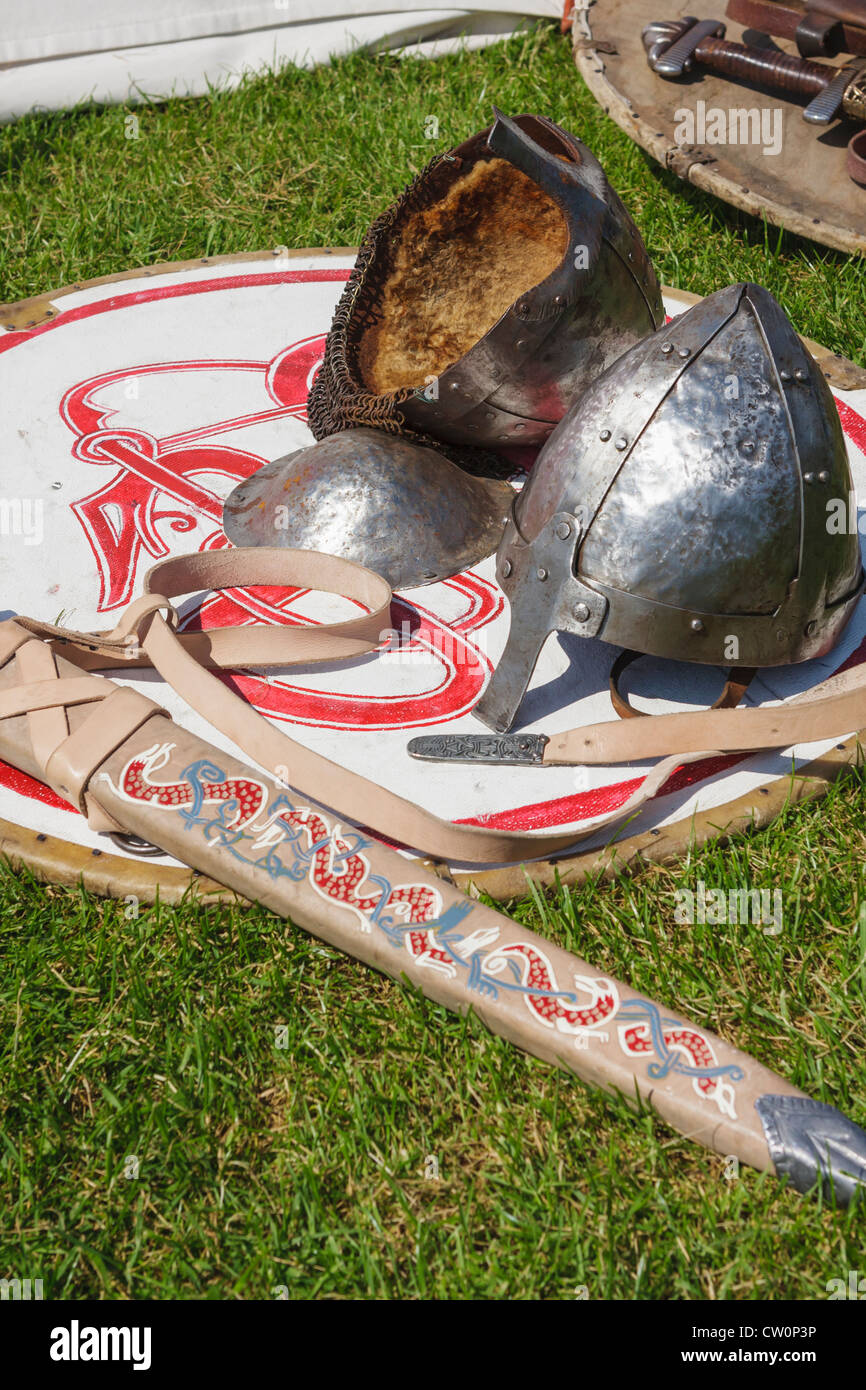 Replica early mediaeval helmets and sword rest on a shield Stock Photo
