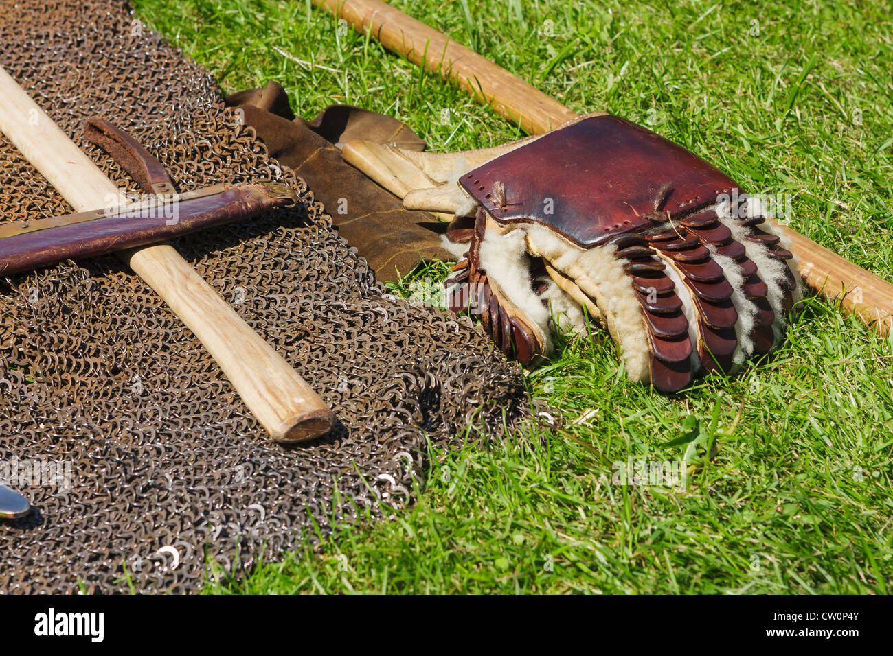 Replica early mediaeval glove and chainmail rests on the ground Stock Photo