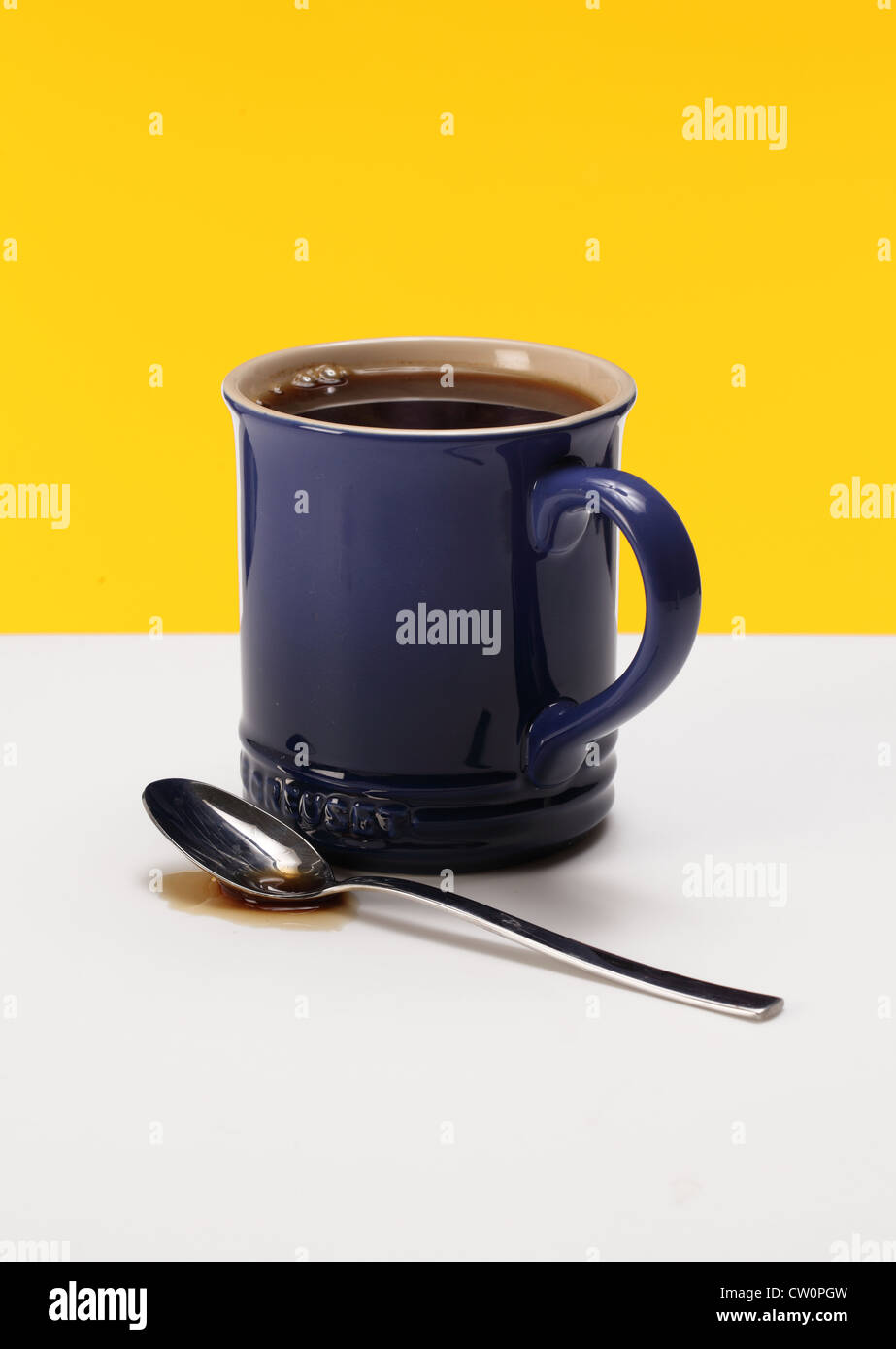 A coffee mug with a spoon and coffee liquid. Stock Photo