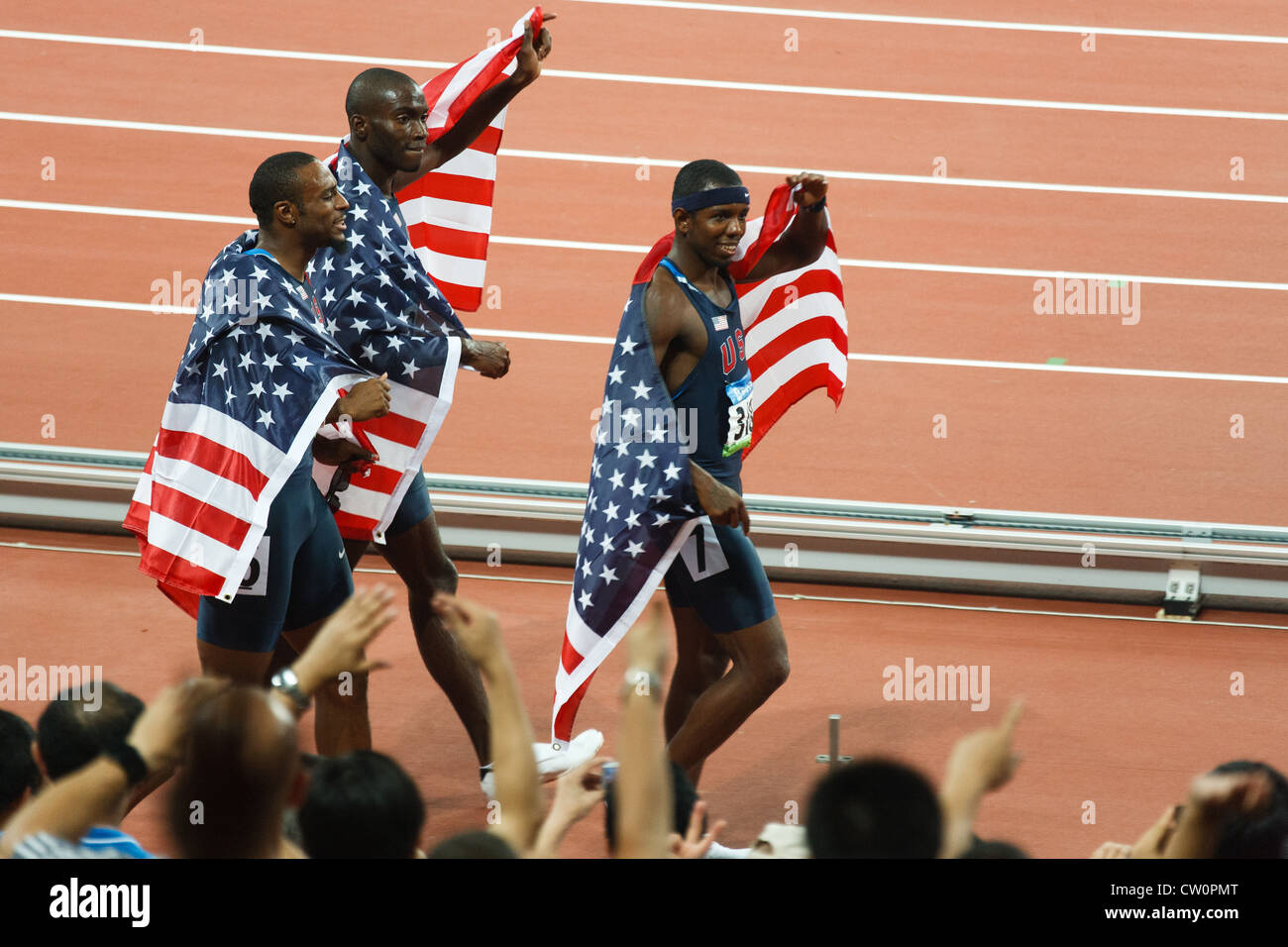 Taylor Clement and Jackson take a victory lap after USA sweeps men's 400 meter hurdles winning gold silver bronze medals Stock Photo