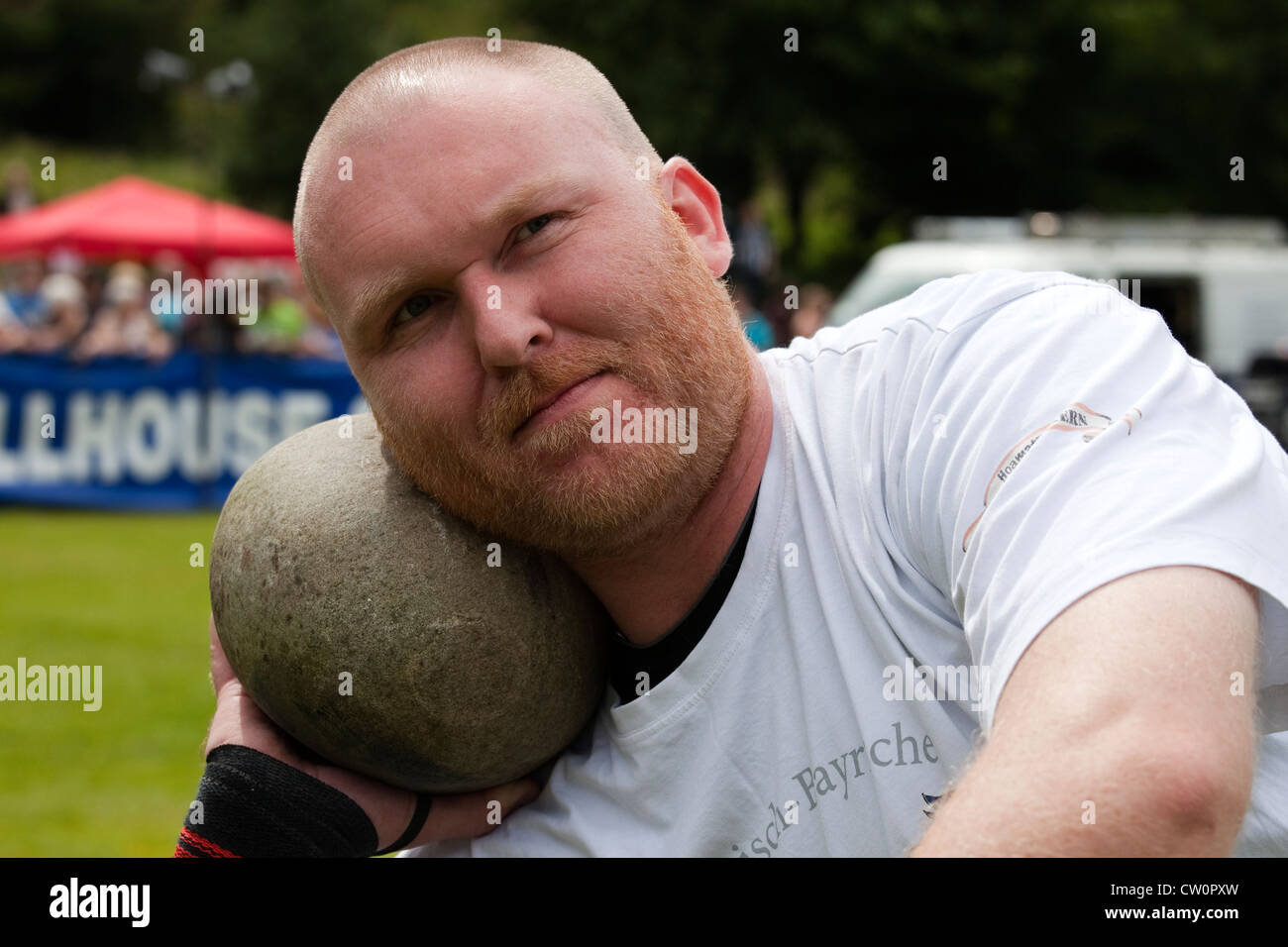 John Neill competing in Highland Games and throwing the stone at Dundonald Highland Games, Ayrshire, Scotland, UK Stock Photo
