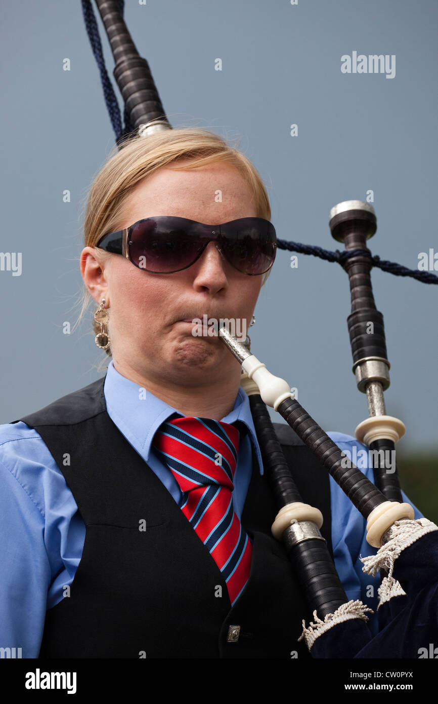 Adult woman playing the bagpipes, Dundonald Highland Games, Ayrshire, Scotland, UK Stock Photo