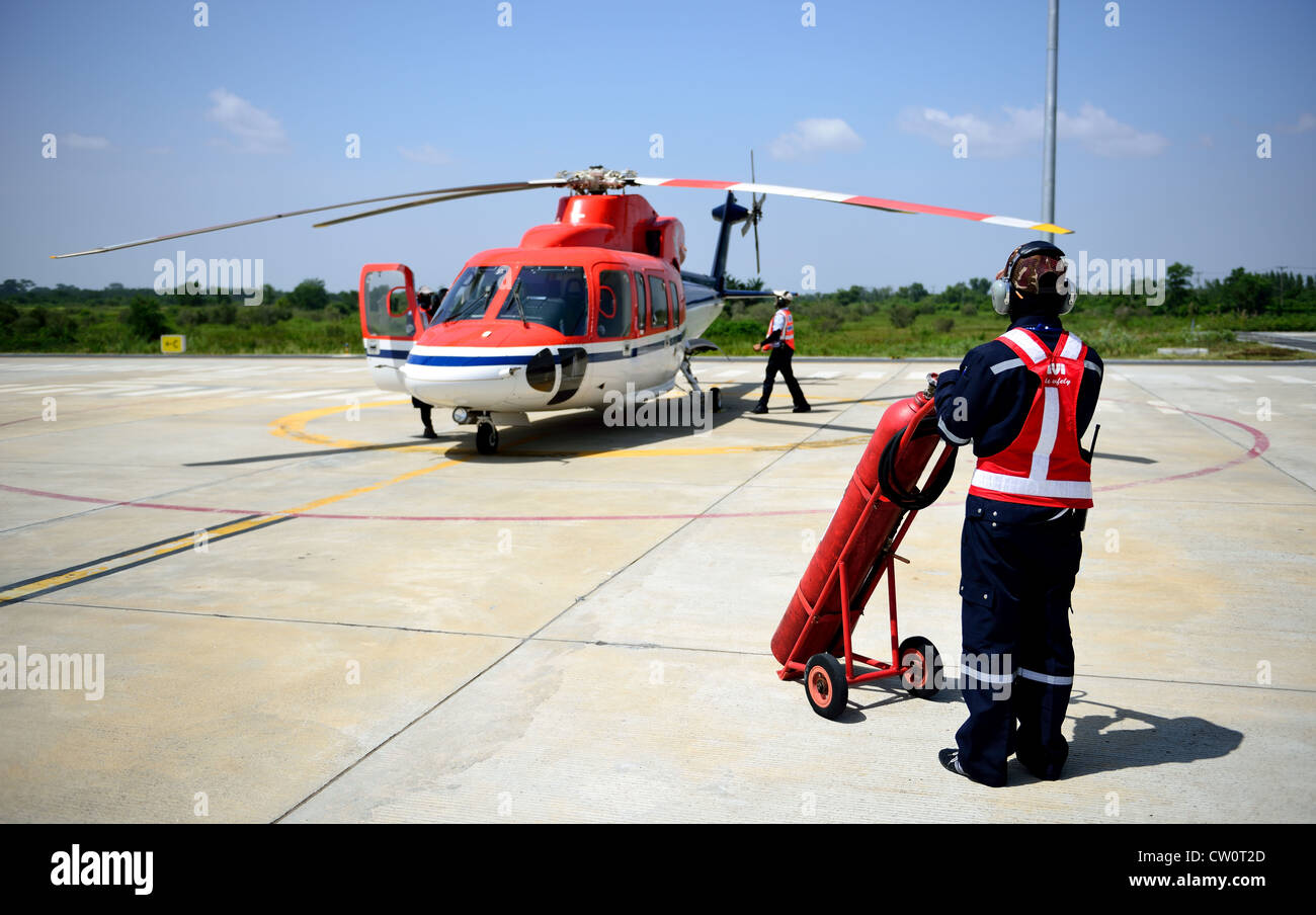 fireman is guarding for helicopter before start up engine. Stock Photo
