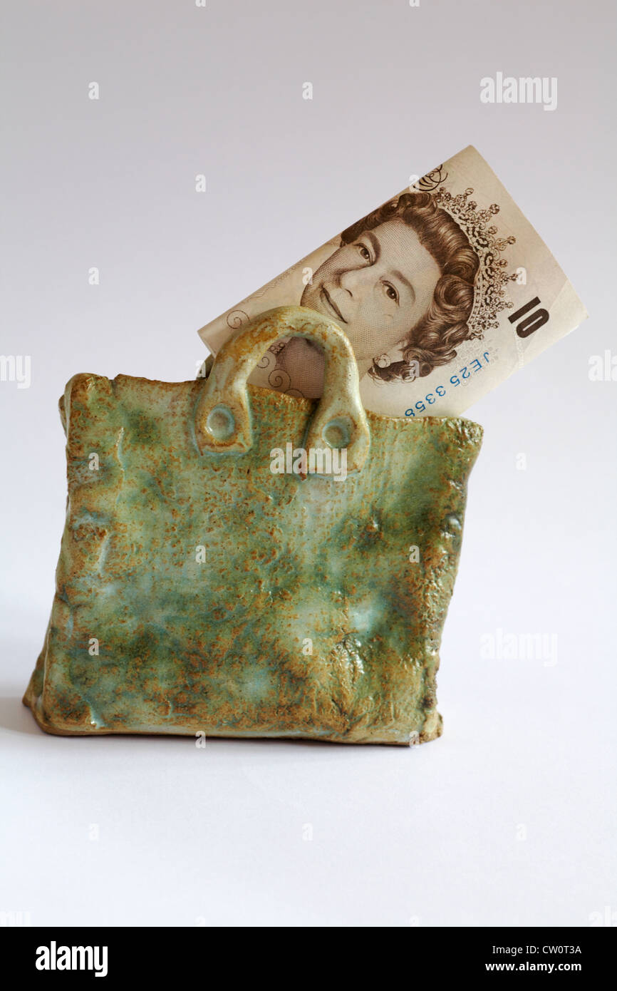 bag of money - £10 note in pottery bag isolated on white background Stock Photo