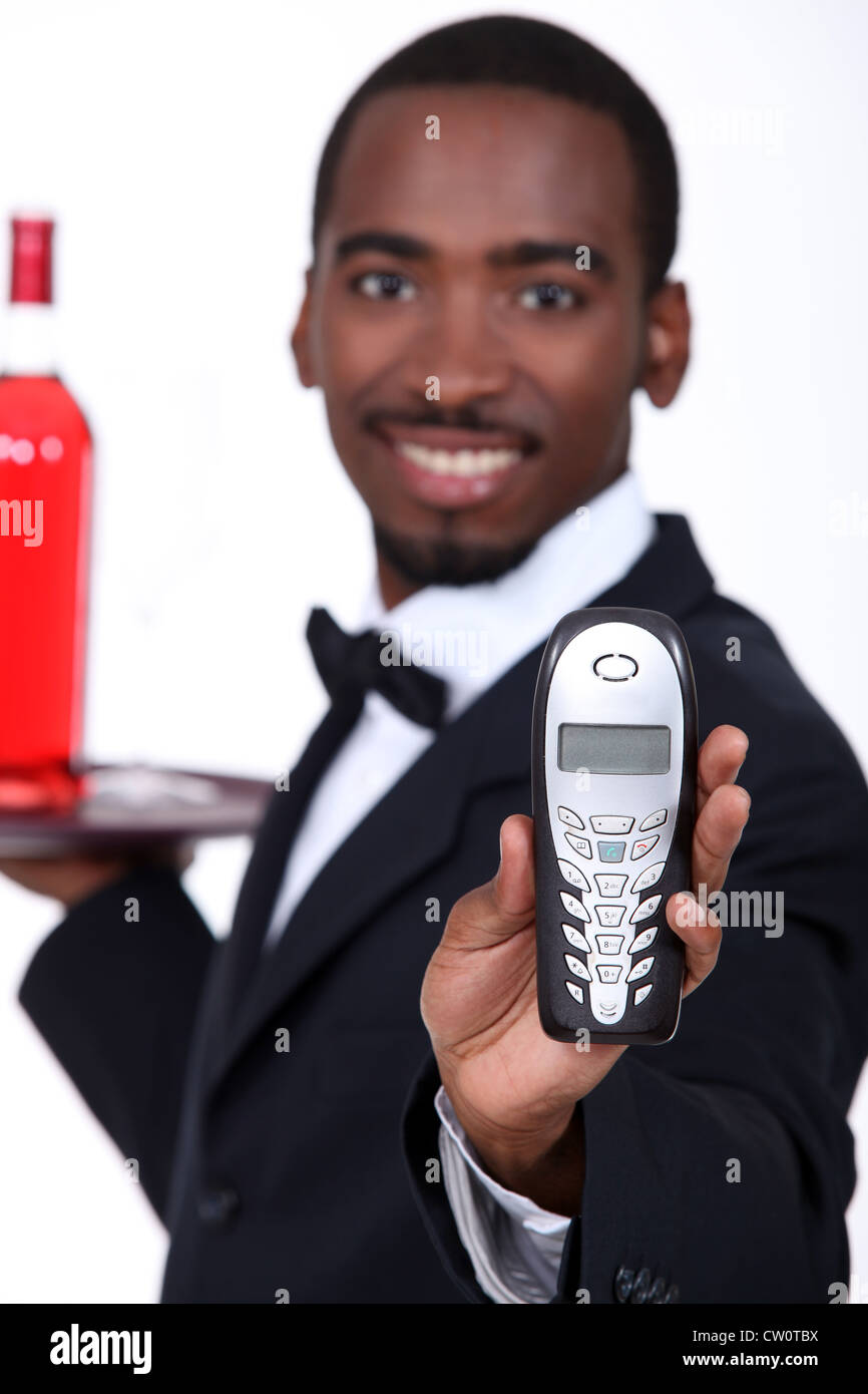 Male server holding mobile telephone Stock Photo - Alamy
