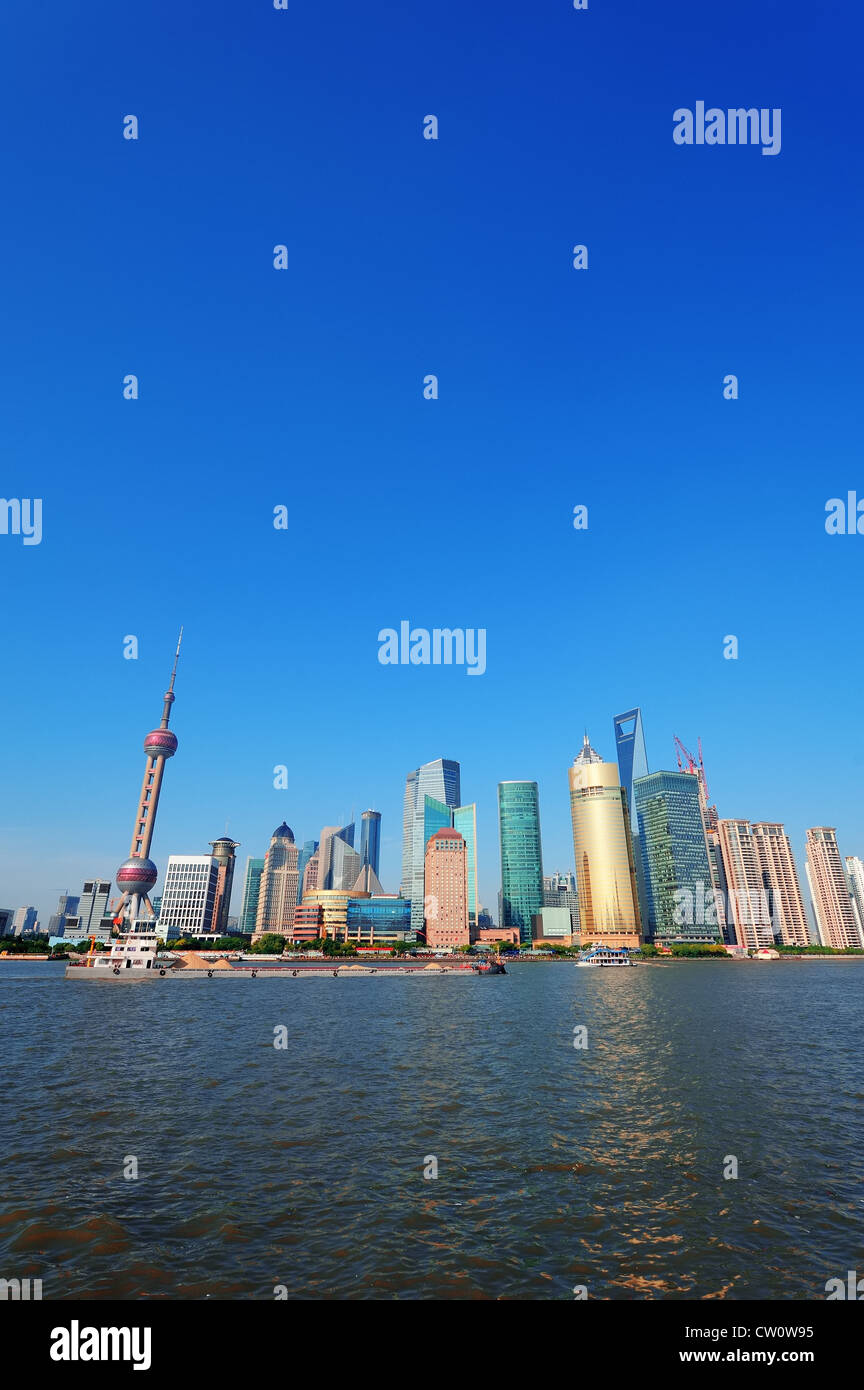 Shanghai skyline with skyscrapers and blue clear sky over Huangpu River ...