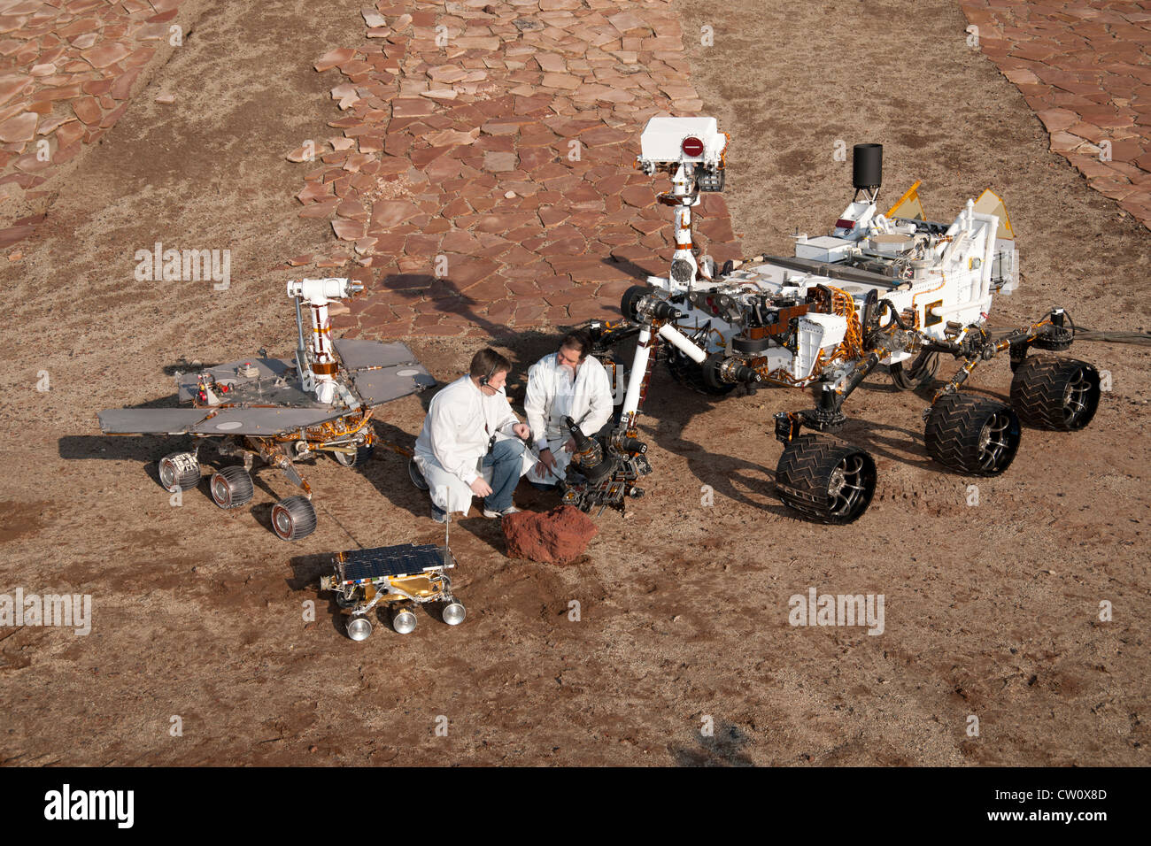 Two spacecraft engineers with Mars rovers: Sojourner, Mars Exploration Rover Project test rover and Curiosity Stock Photo