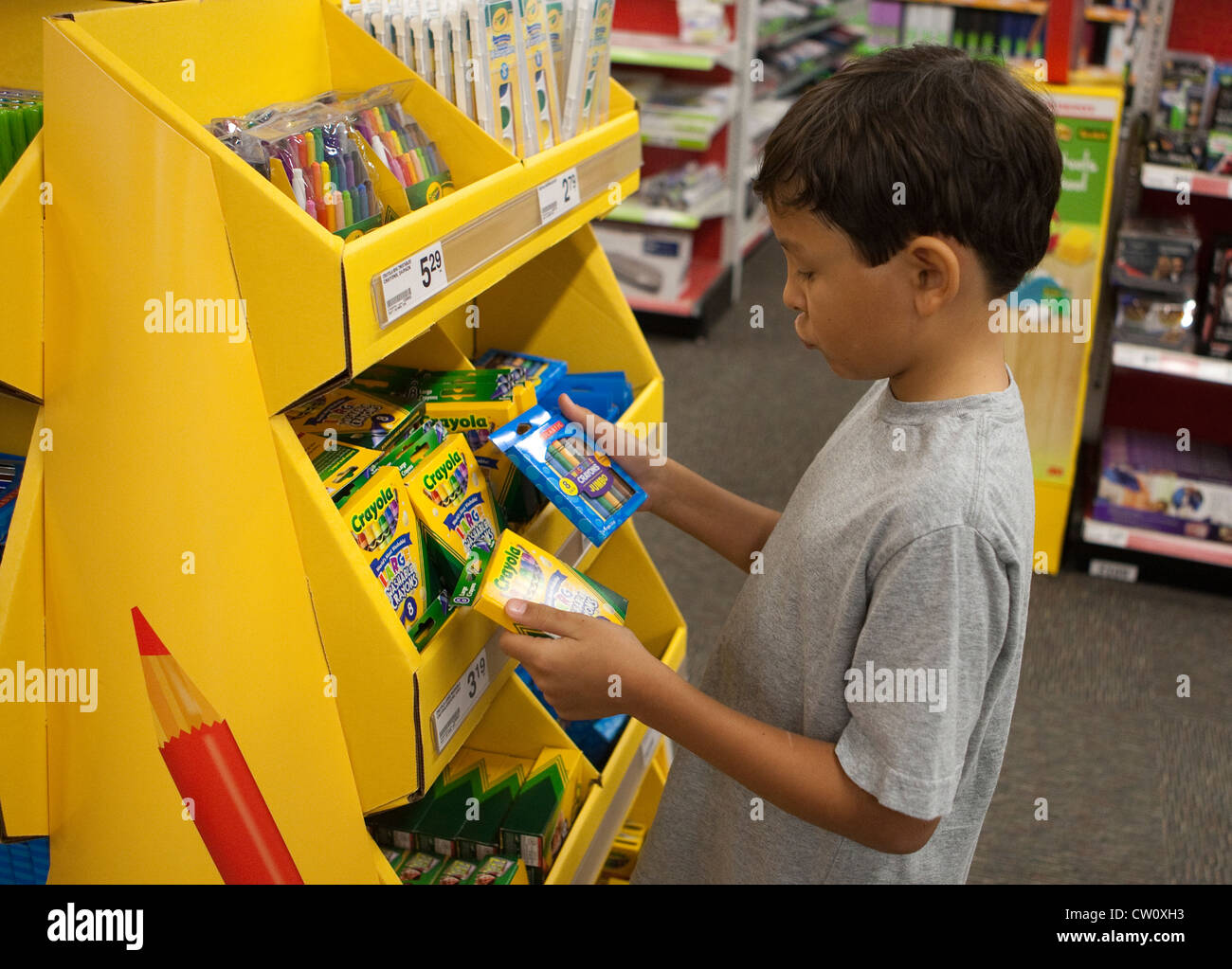 8 year old Mexican-American boy, shops for his third grade elementary school supplies at office supply store Stock Photo