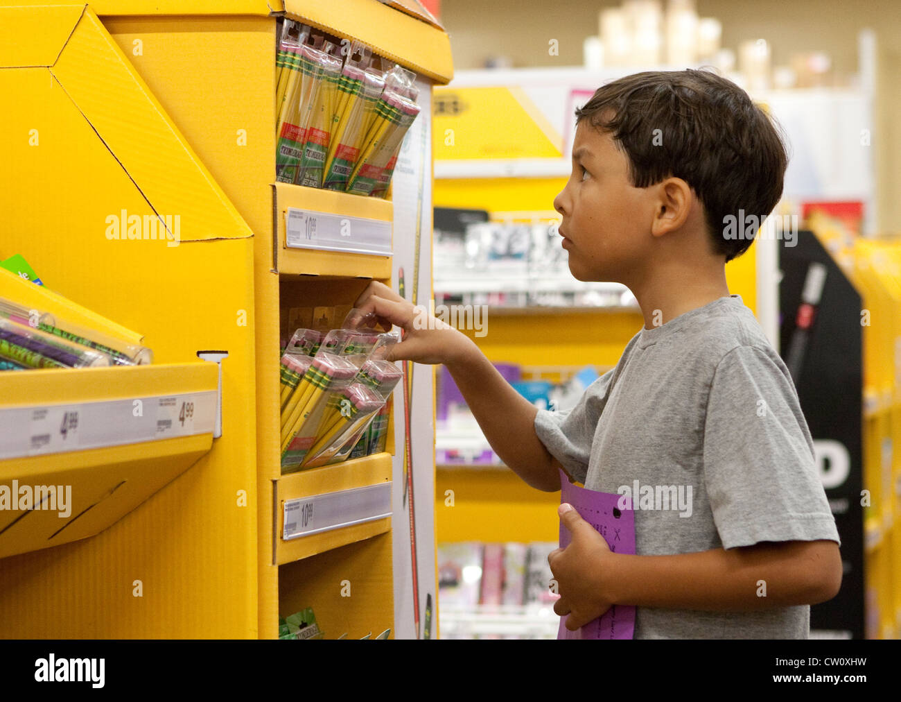 8 year old Mexican-American boy, shops for his third grade elementary school supplies at office supply store Stock Photo