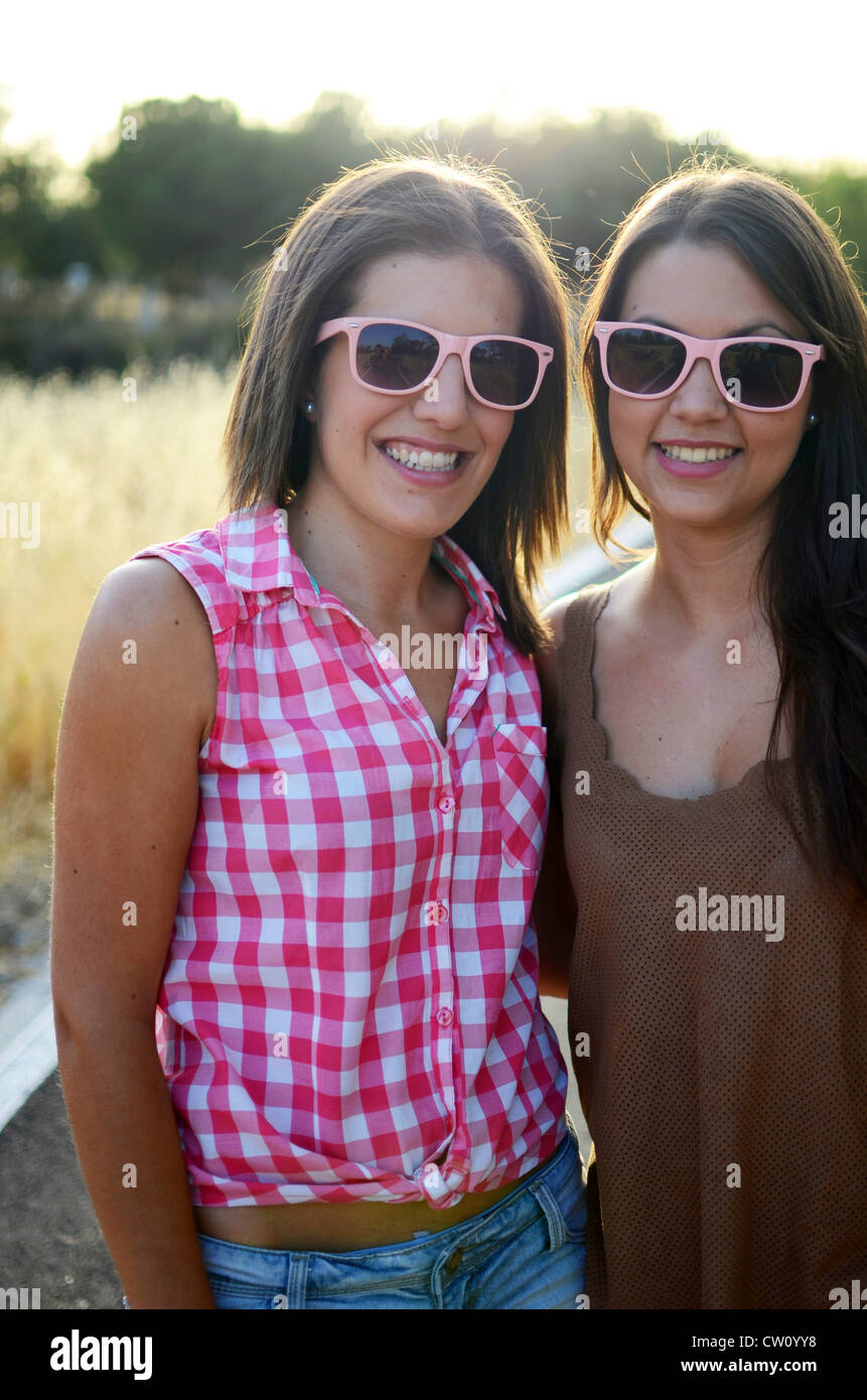 Two attractive young women posing at sunset Stock Photo - Alamy