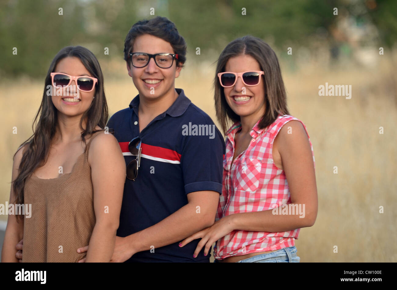 Two young women and a young man have fun outdoors Stock Photo - Alamy
