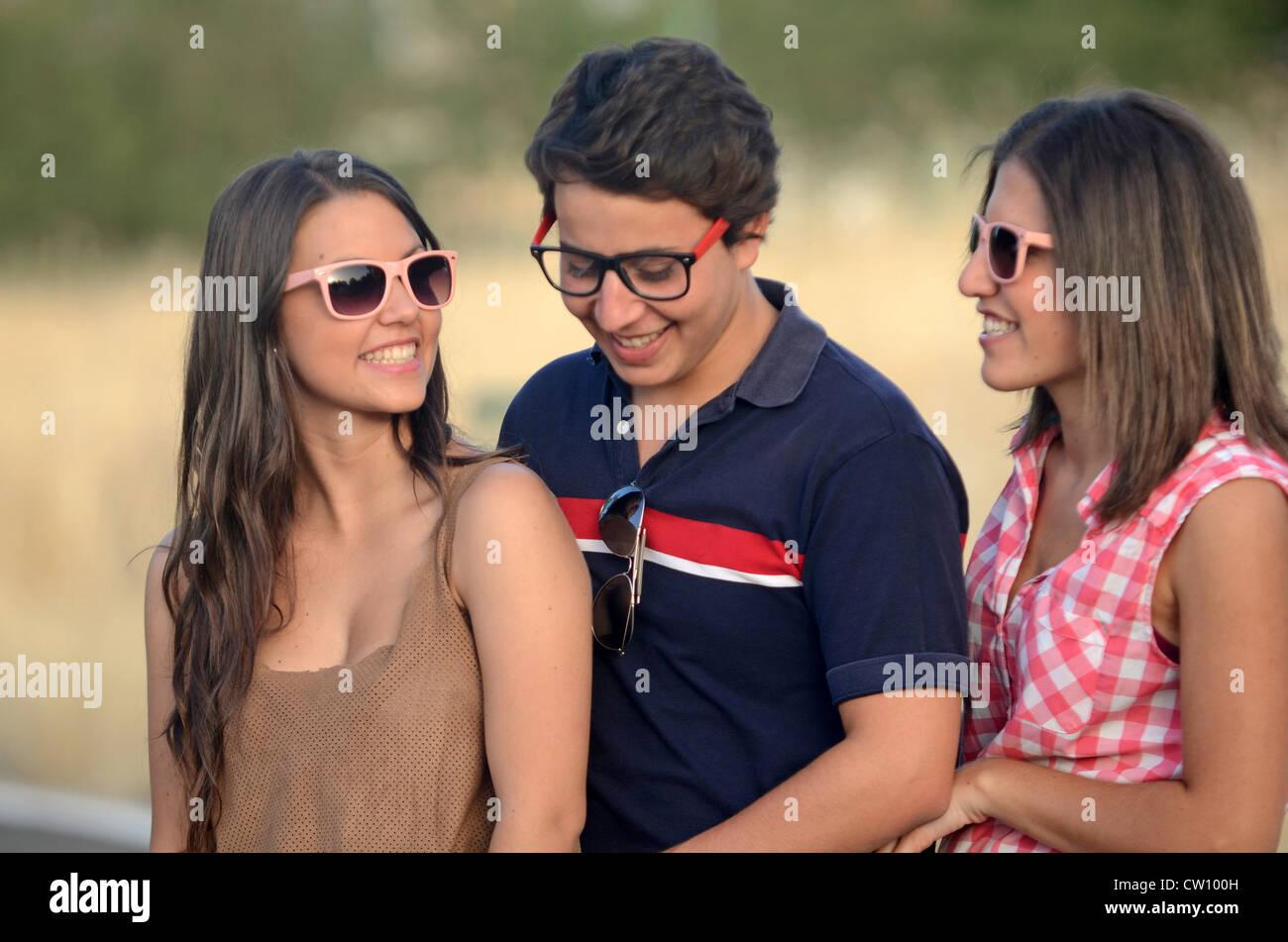 Two young women and a young man have fun outdoors Stock Photo - Alamy