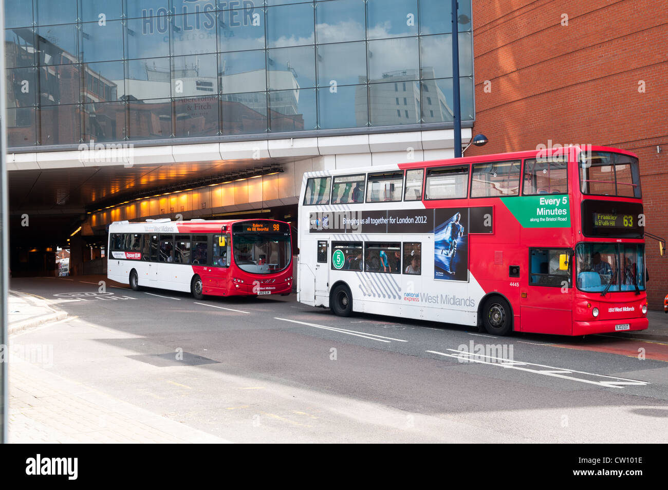 Two buses parked outside Birmingham New Street train station Stock