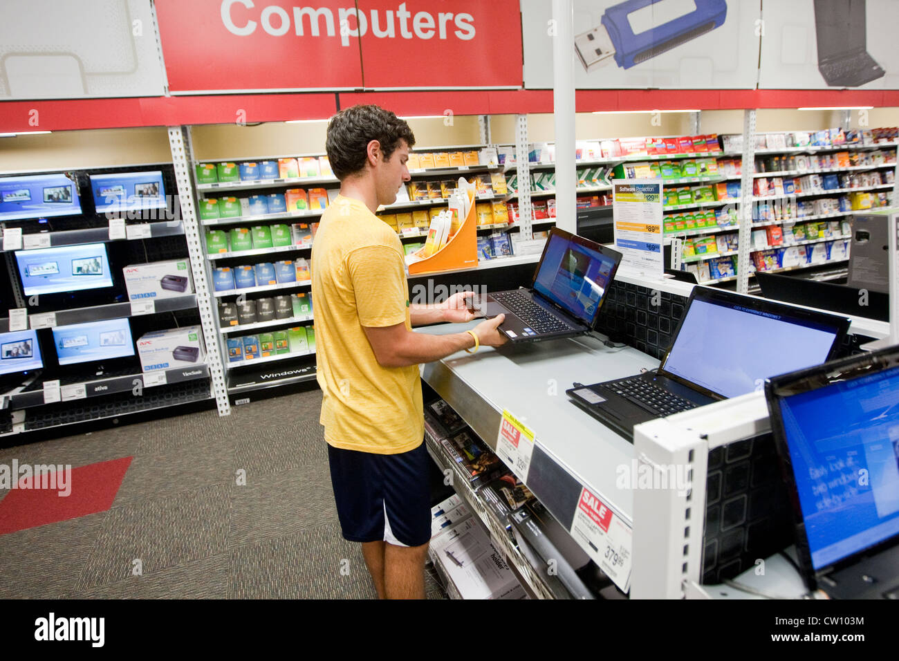 Eighteen year old college freshman shops at office supply store and reviews  computers, tablets, electronic devices Stock Photo - Alamy