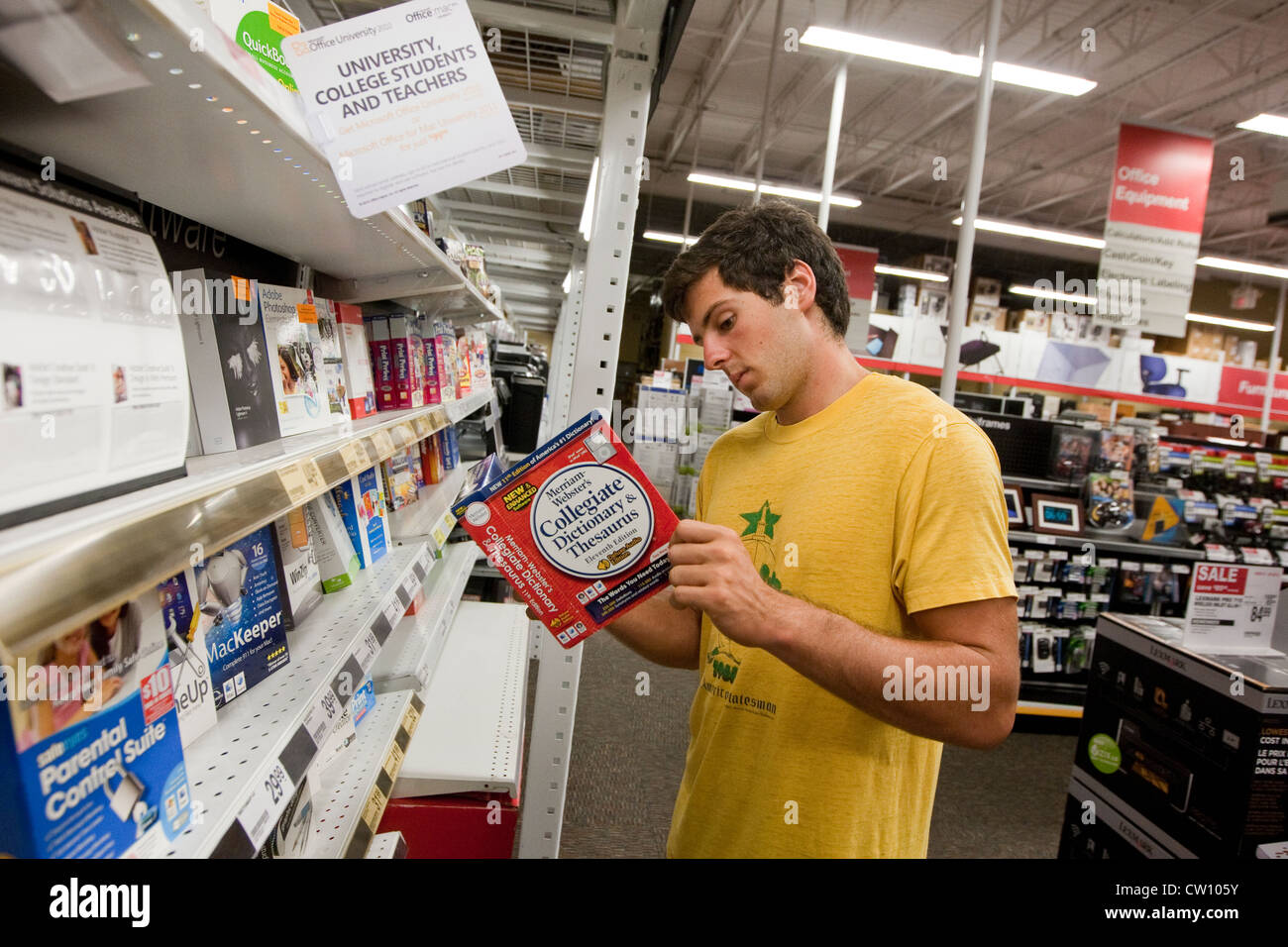 Eighteen year old college freshman shops at office supply store for computer software Stock Photo