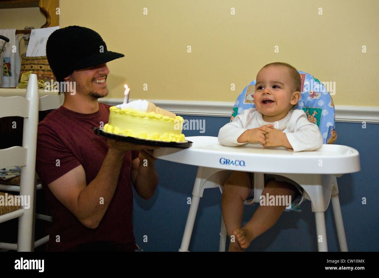 Father Holding Birthday Cake of One Year Old Baby Boy on His Birthday Stock Photo