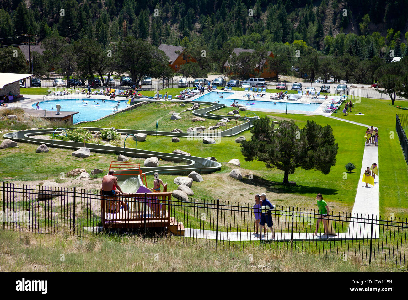 People enjoying the swimming pools and water slide at Mt. Princeton Hot  Springs, Nathrop, Colorado. Editorial use only Stock Photo - Alamy